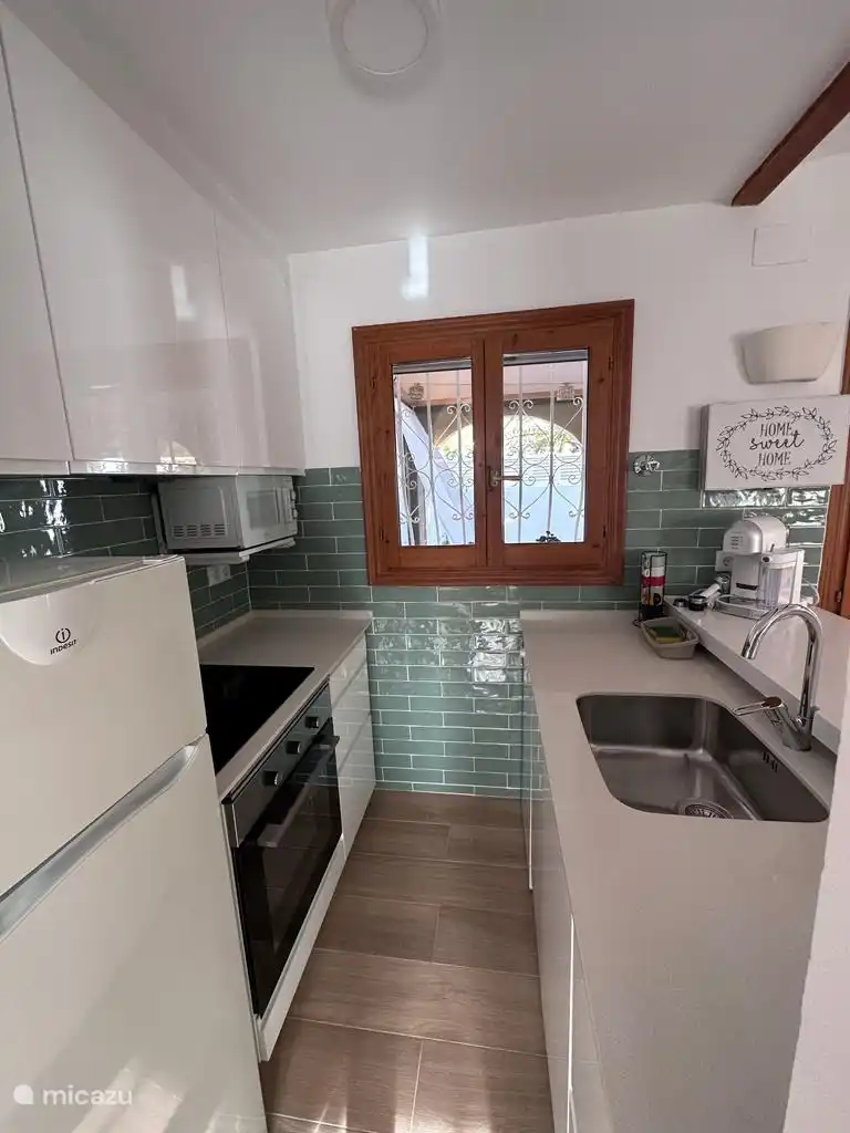 Kitchen with dishwasher, oven, microwave, Nespresso coffee machine, fridge-freezer.