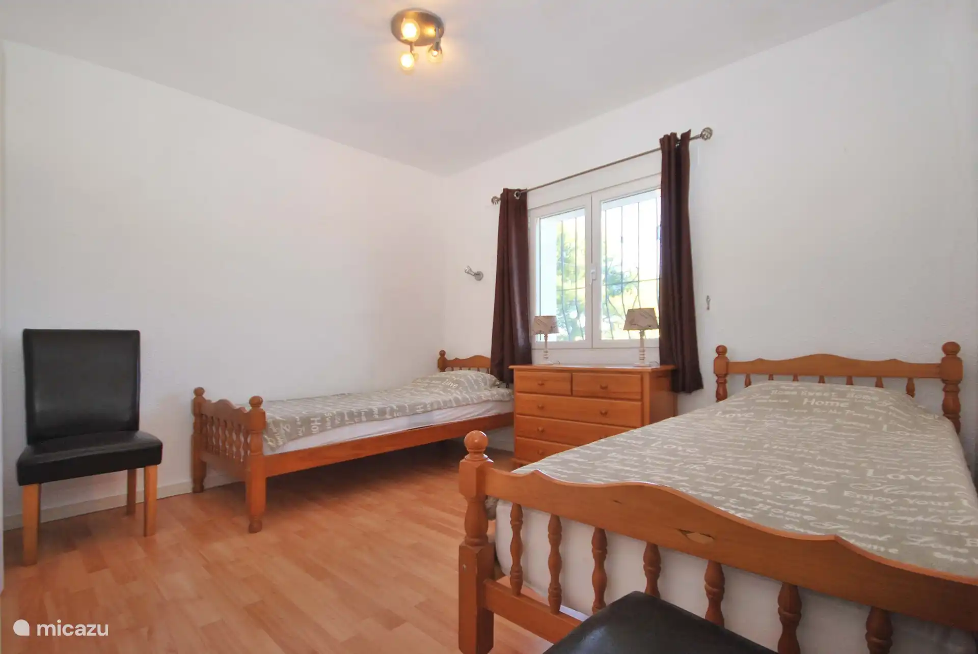 double bedroom upstairs with fan