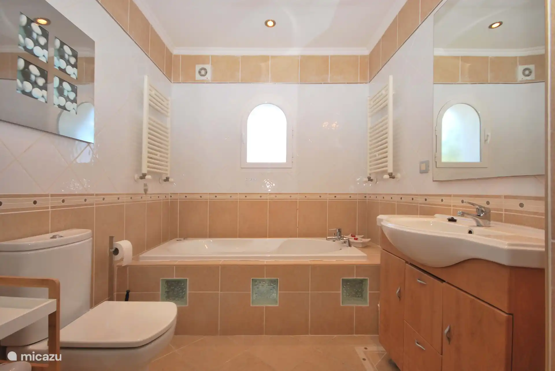 fully equipped bathroom upstairs with toilet, bubble bath and shower
