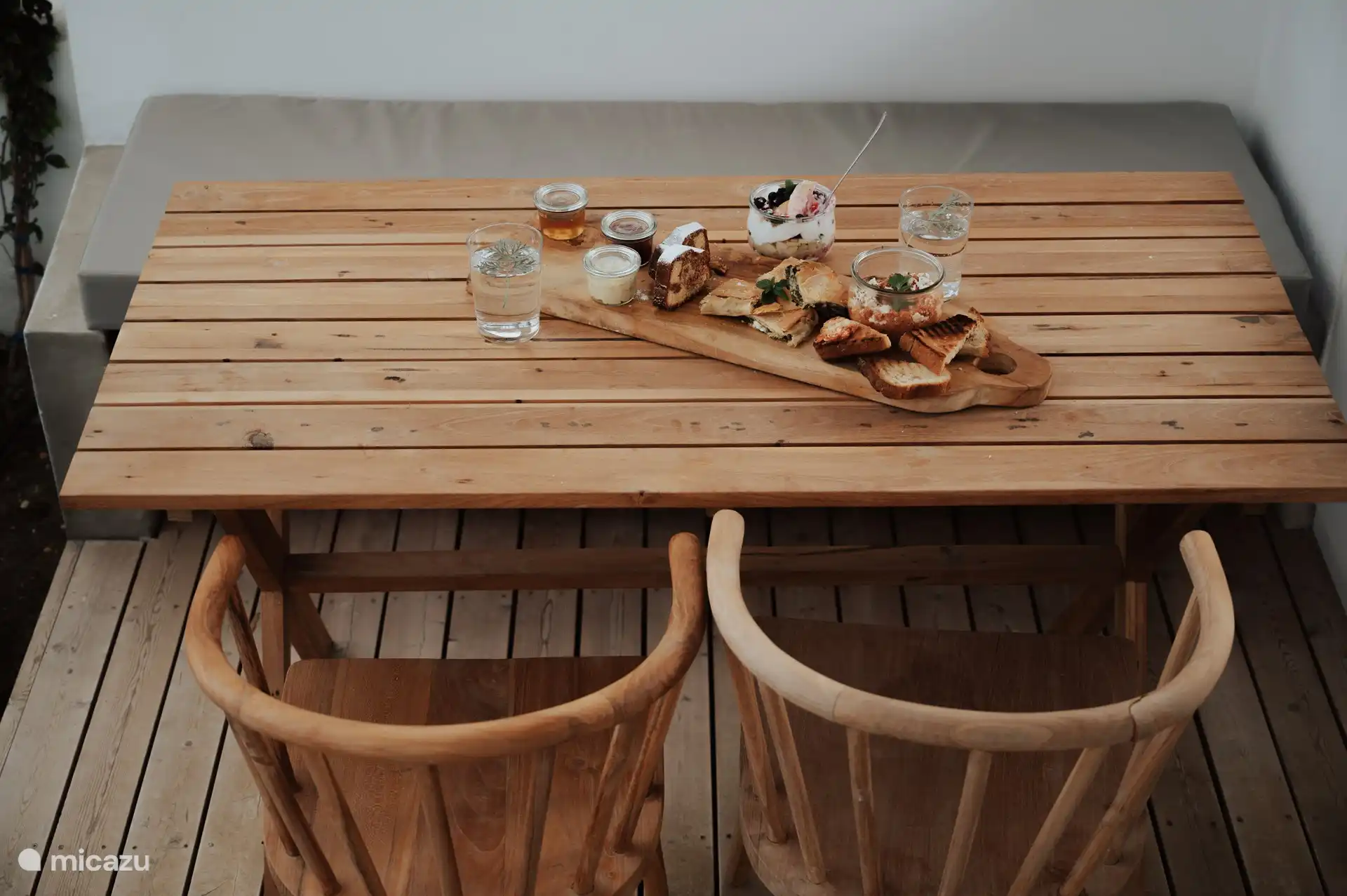 Outdoor teak dining table with breakfast