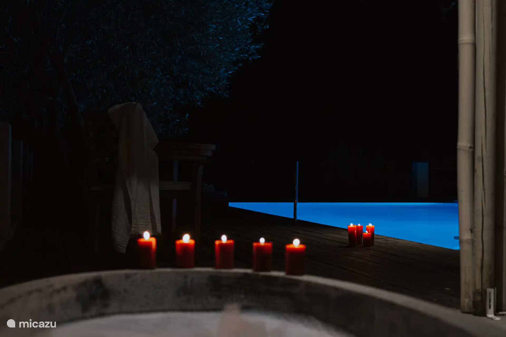 Bathtub poolside with candles