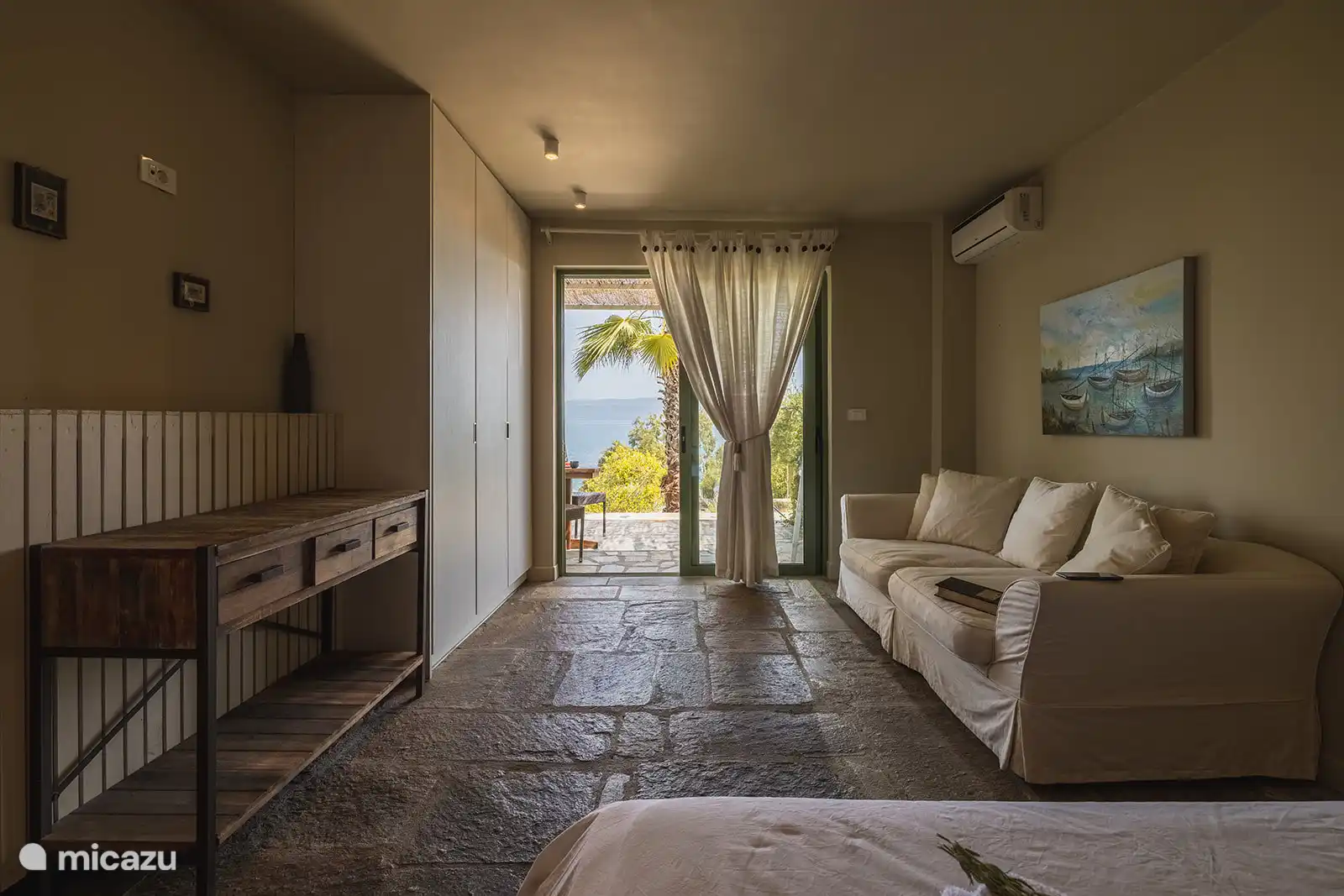 Bedroom with sofa and sea view