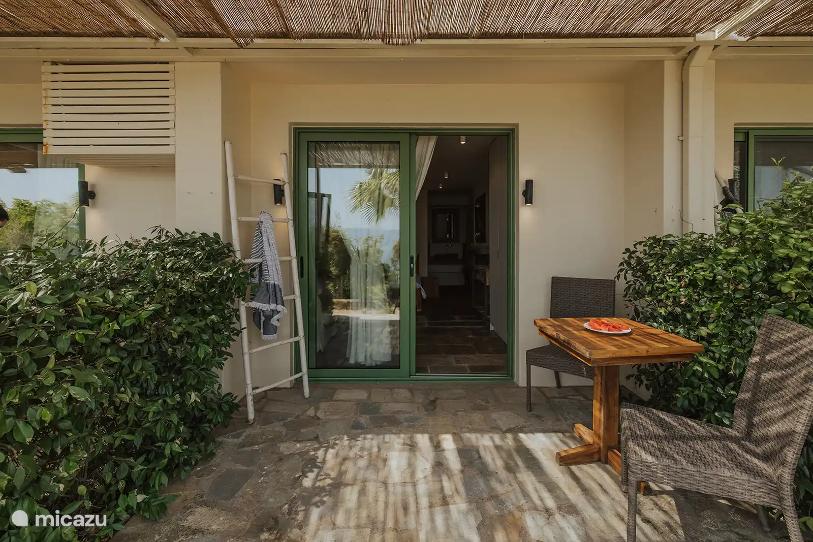 The bedroom’s private outdoor garden seating area