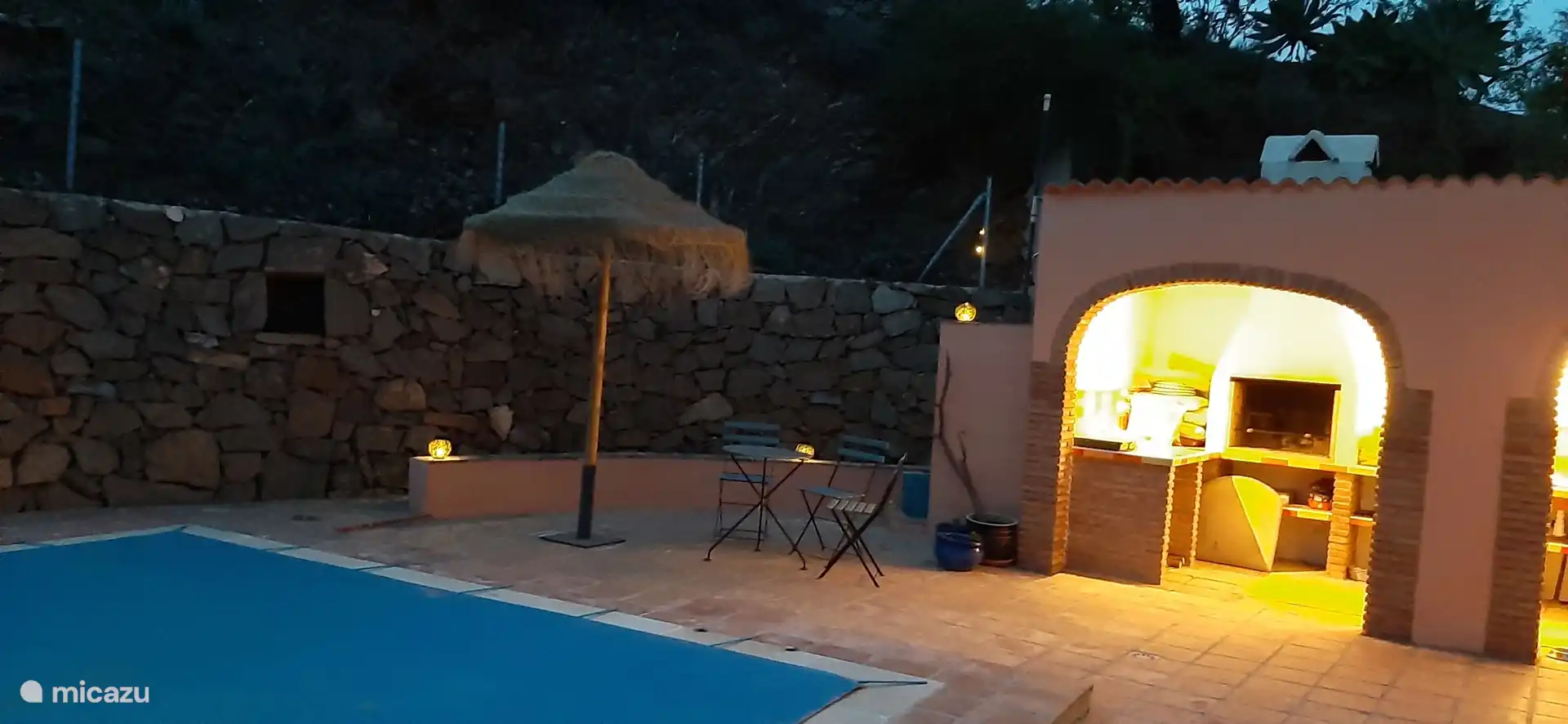 verlichte  buitenkeuken bij valavond