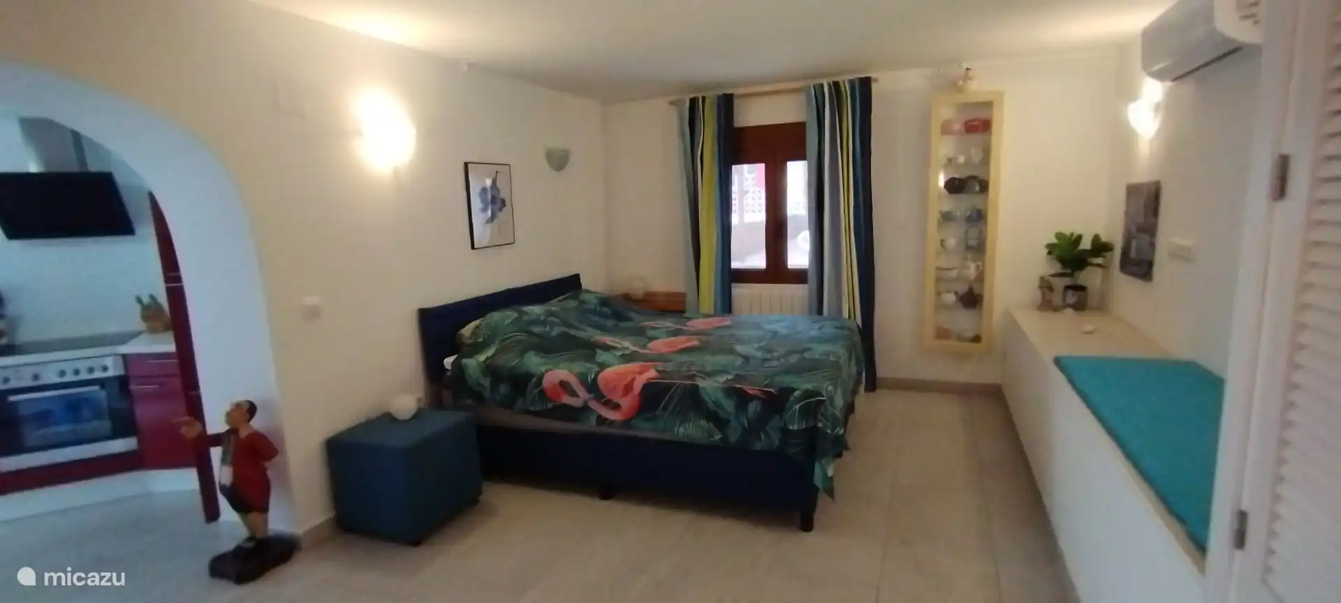 In het appartement staat een tweepersoonsbed. Alle ramen zijn voorzien van horren en gordijnen. 