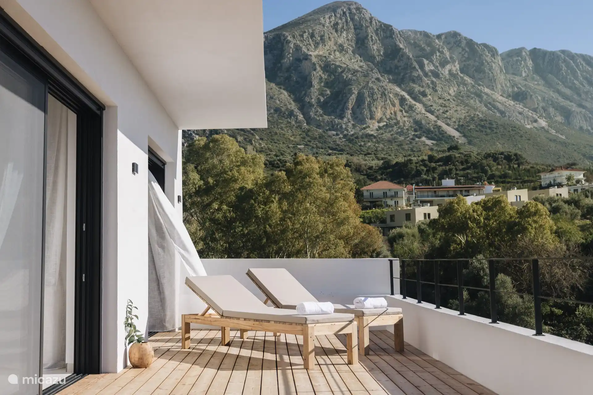 Decked yard with sunbeds 