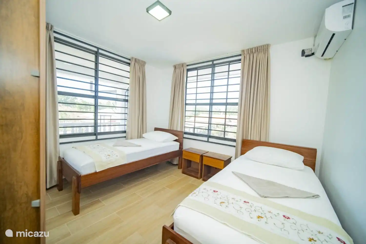 3rd bedroom with 2 x 1 person beds.  The room is equipped with air conditioning and a spacious wardrobe. There is also a mosquito net for windows.