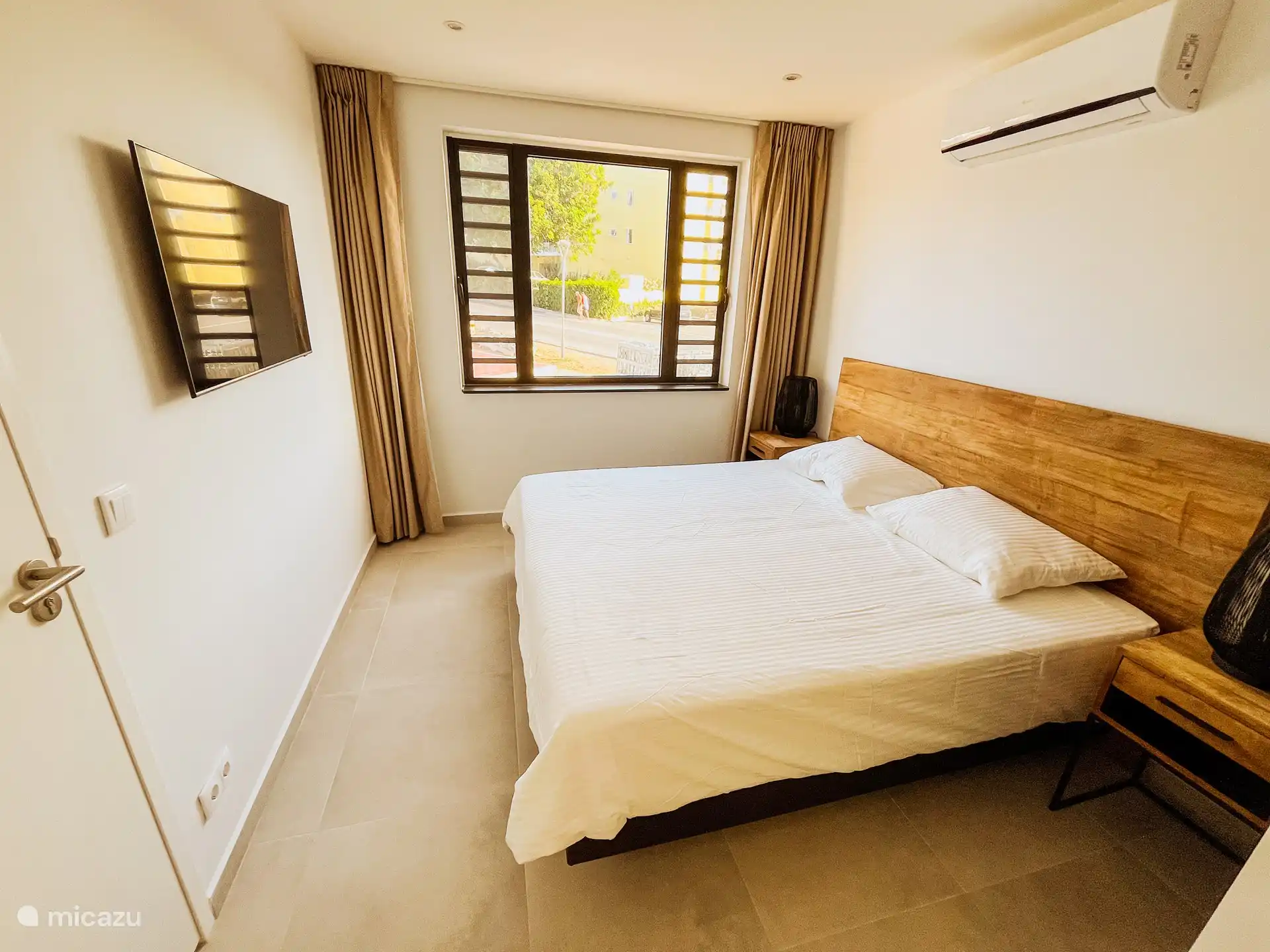 Amplio dormitorio con aire acondicionado y smart TV.