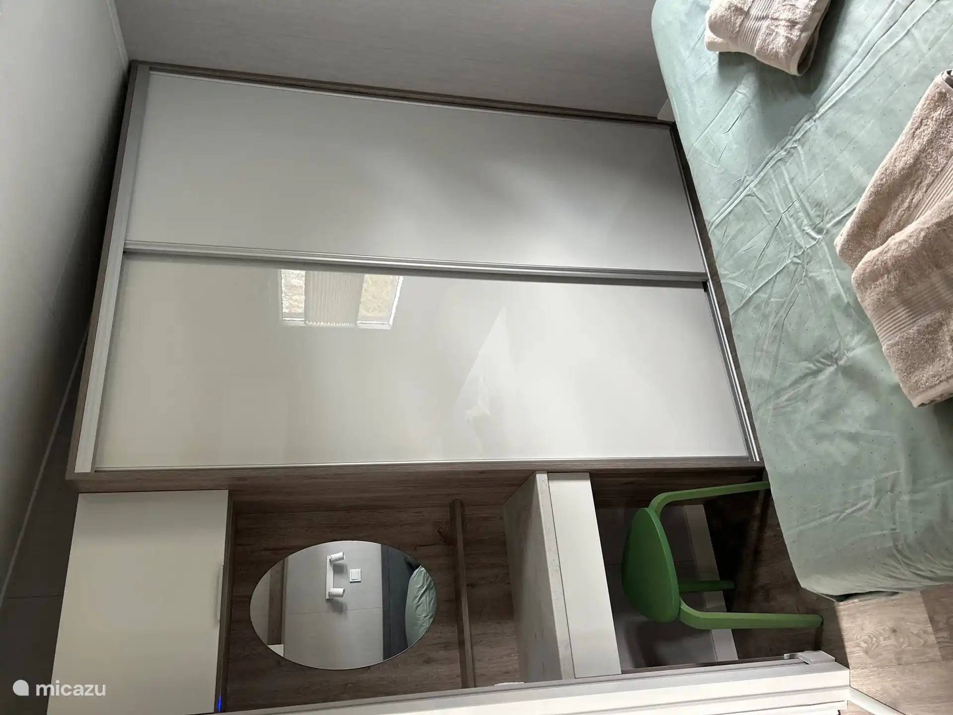Sufficient storage options in the cupboard plus a small seat with mirror.