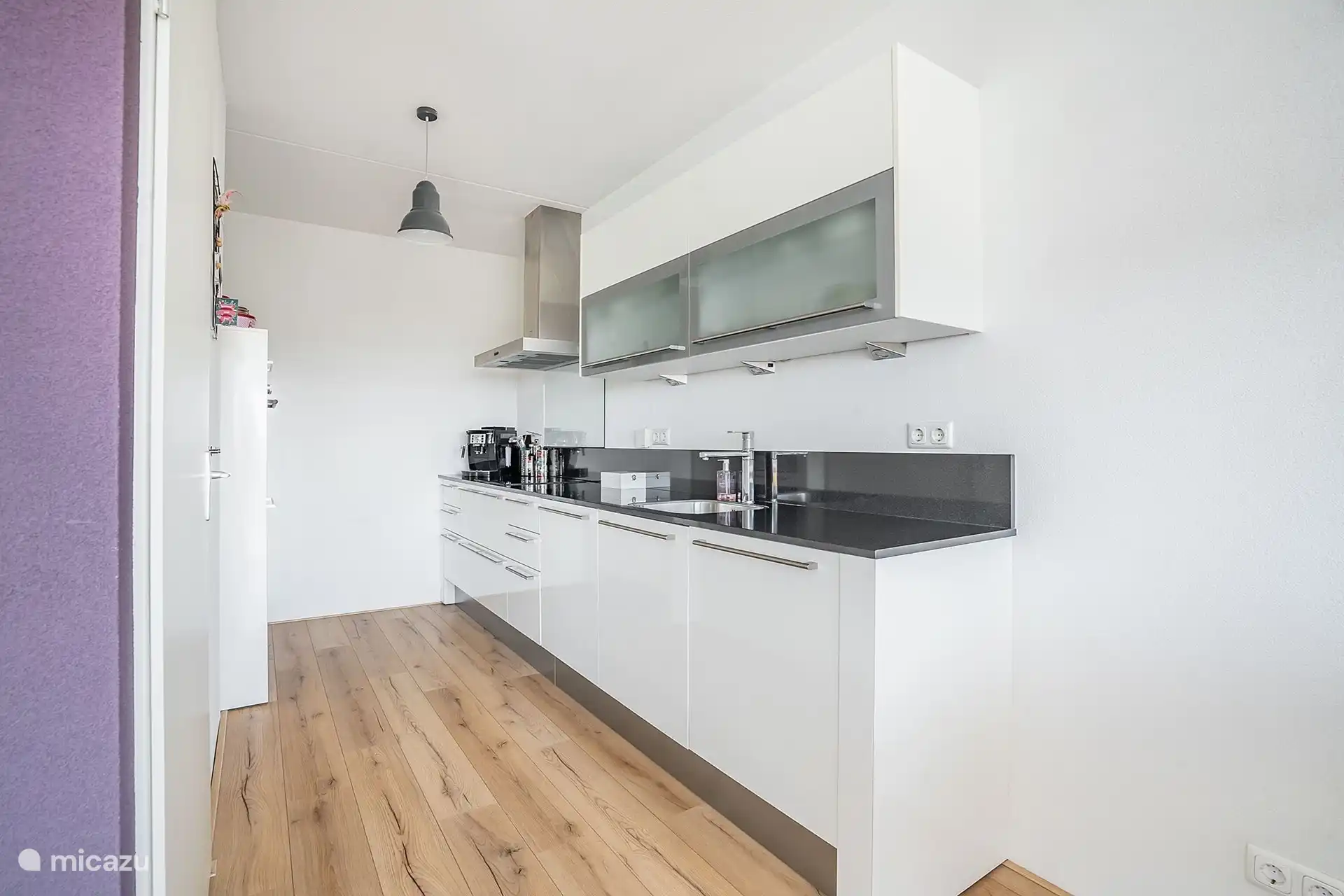 Kitchen including dishwasher, oven, kettle and coffee maker