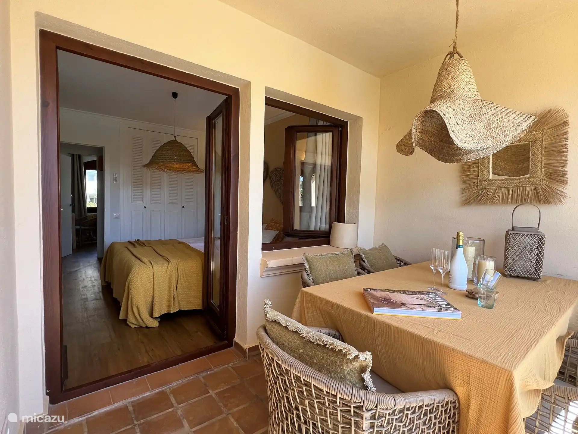 Esta es la terraza cubierta donde podrá sentarse a la mesa a la sombra, orientada al sur con una hermosa vista al jardín comunitario con piscina. 