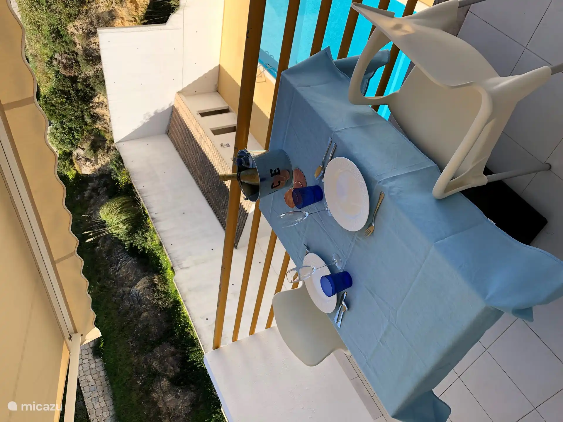 Balcony with spacious dining table and view of the swimming pool