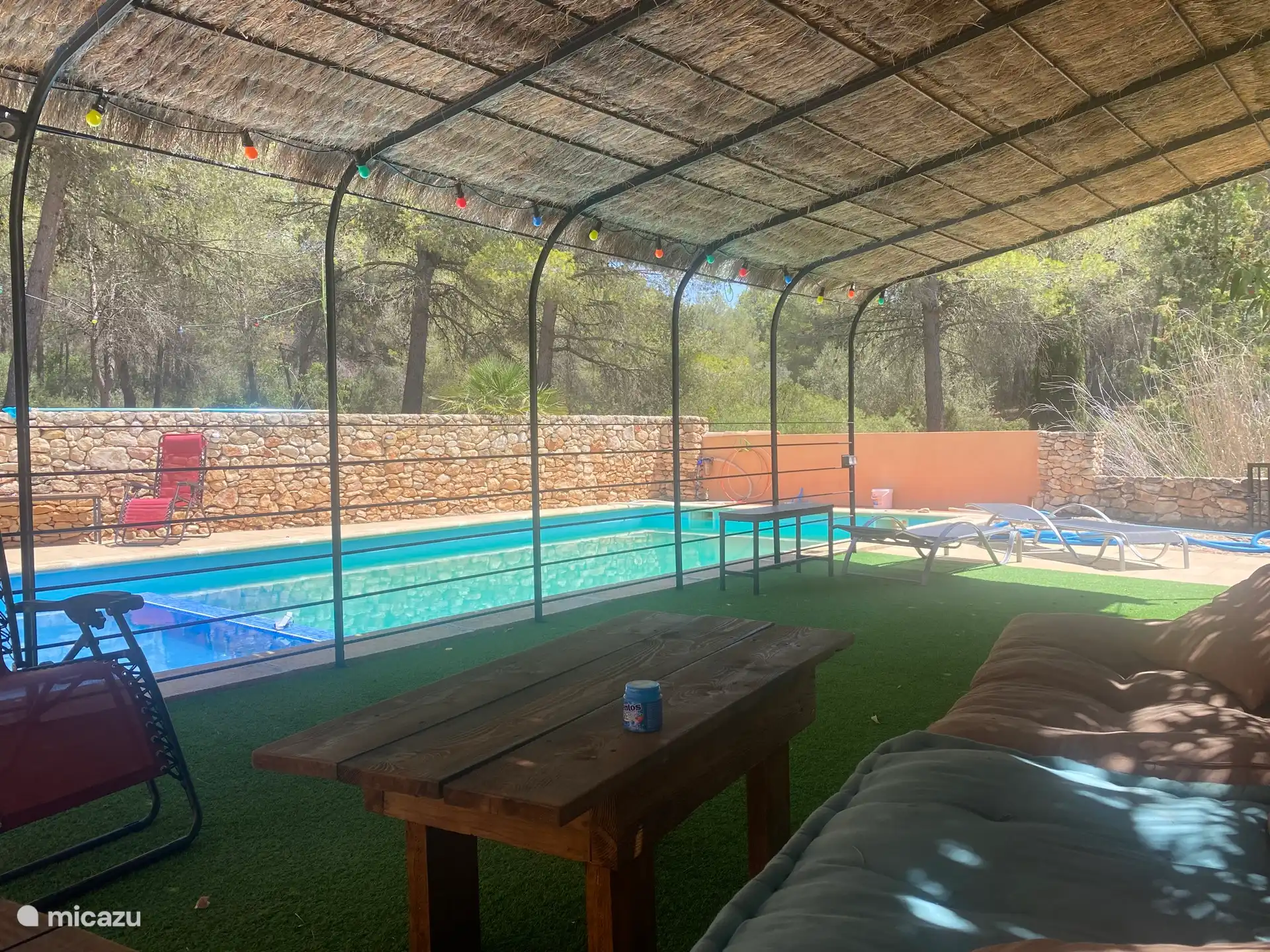 The lounge sofa in the shade by the pool. 