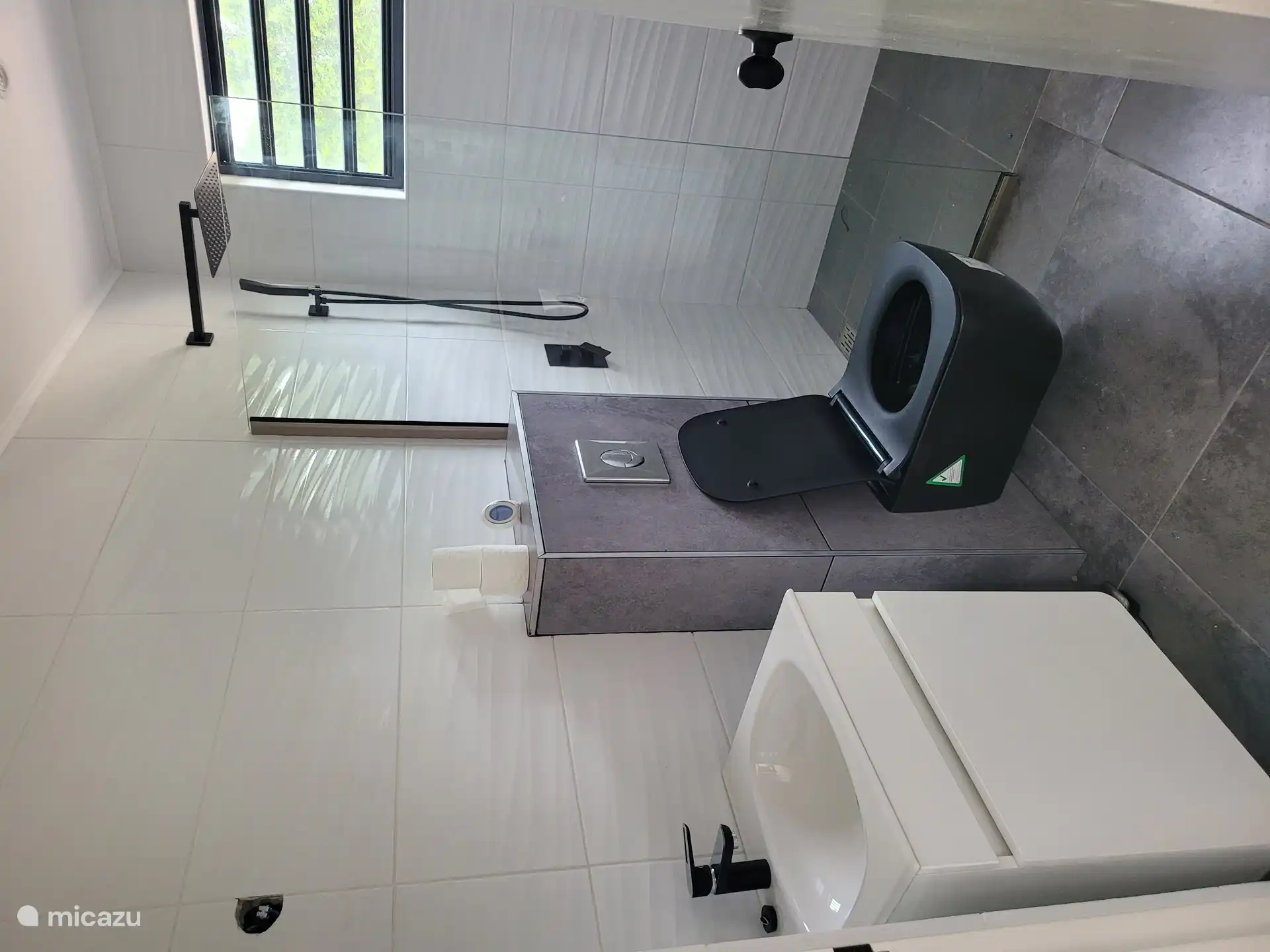 Bathroom with shower, sink with mirror and toilet