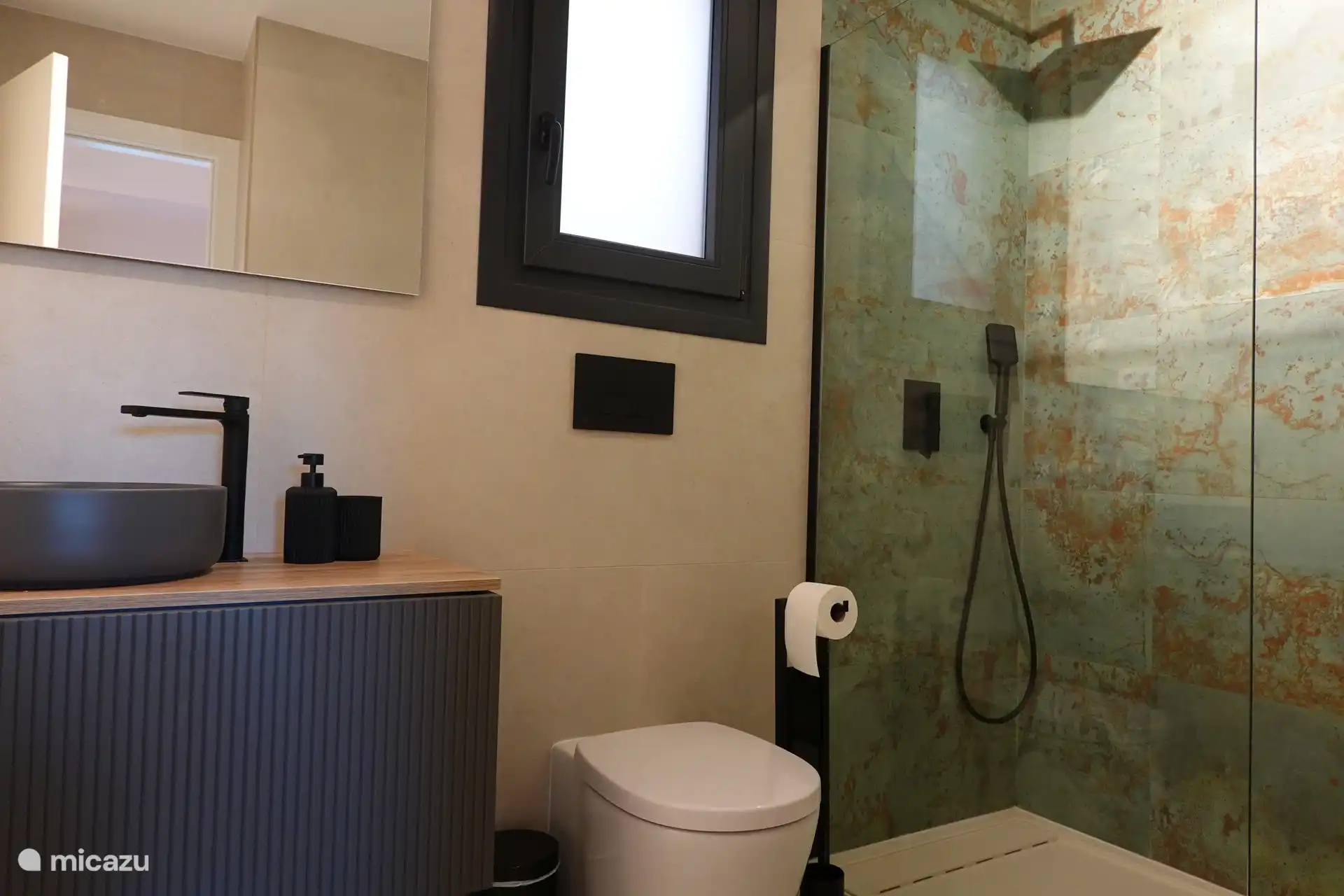 A bathroom where you can relax with a rain shower.