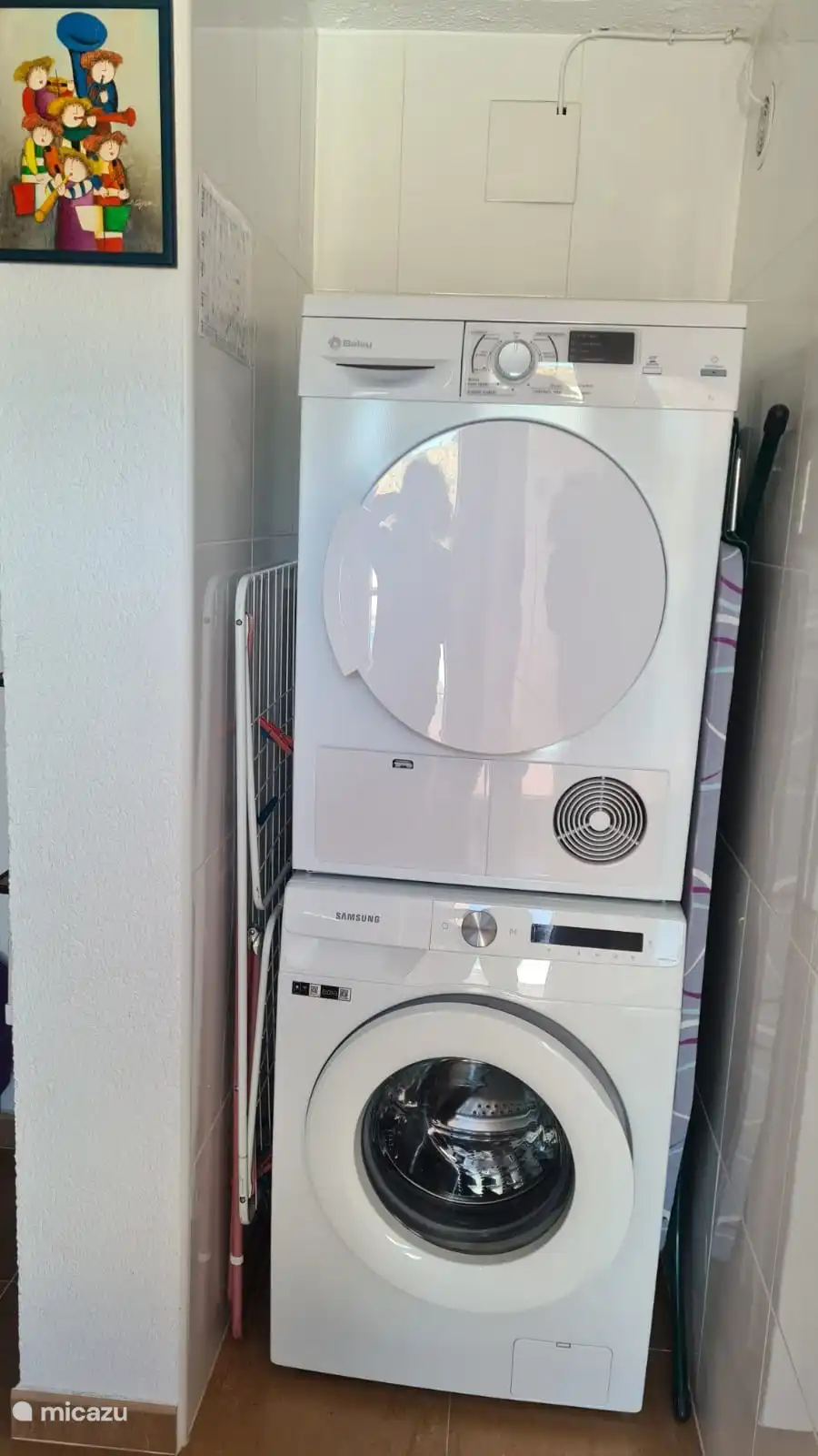 Laundry room with washing machine, dryer, drying rack, iron