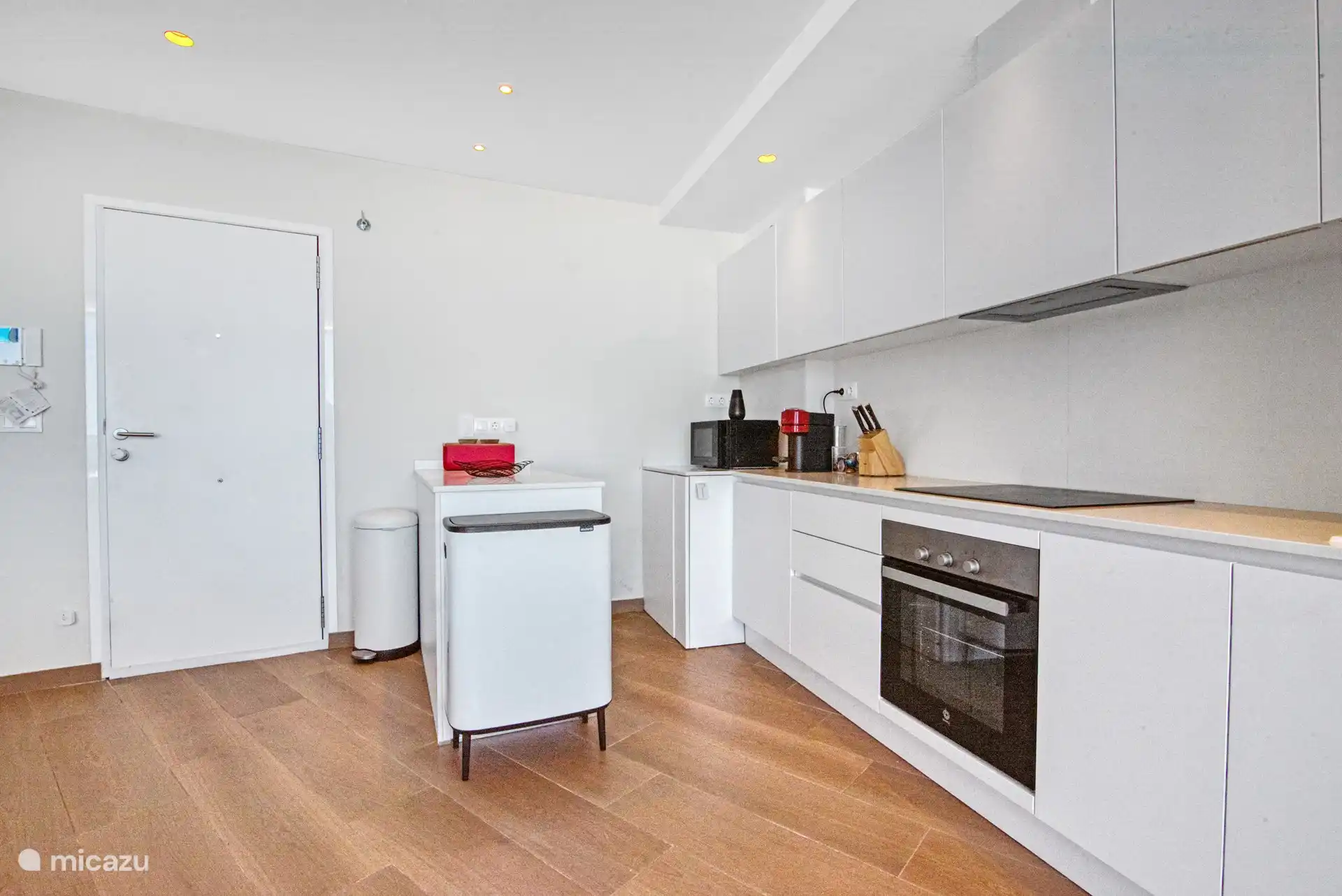 another perspective photo from the kitchen, where all equipment is present and sufficient storage space.