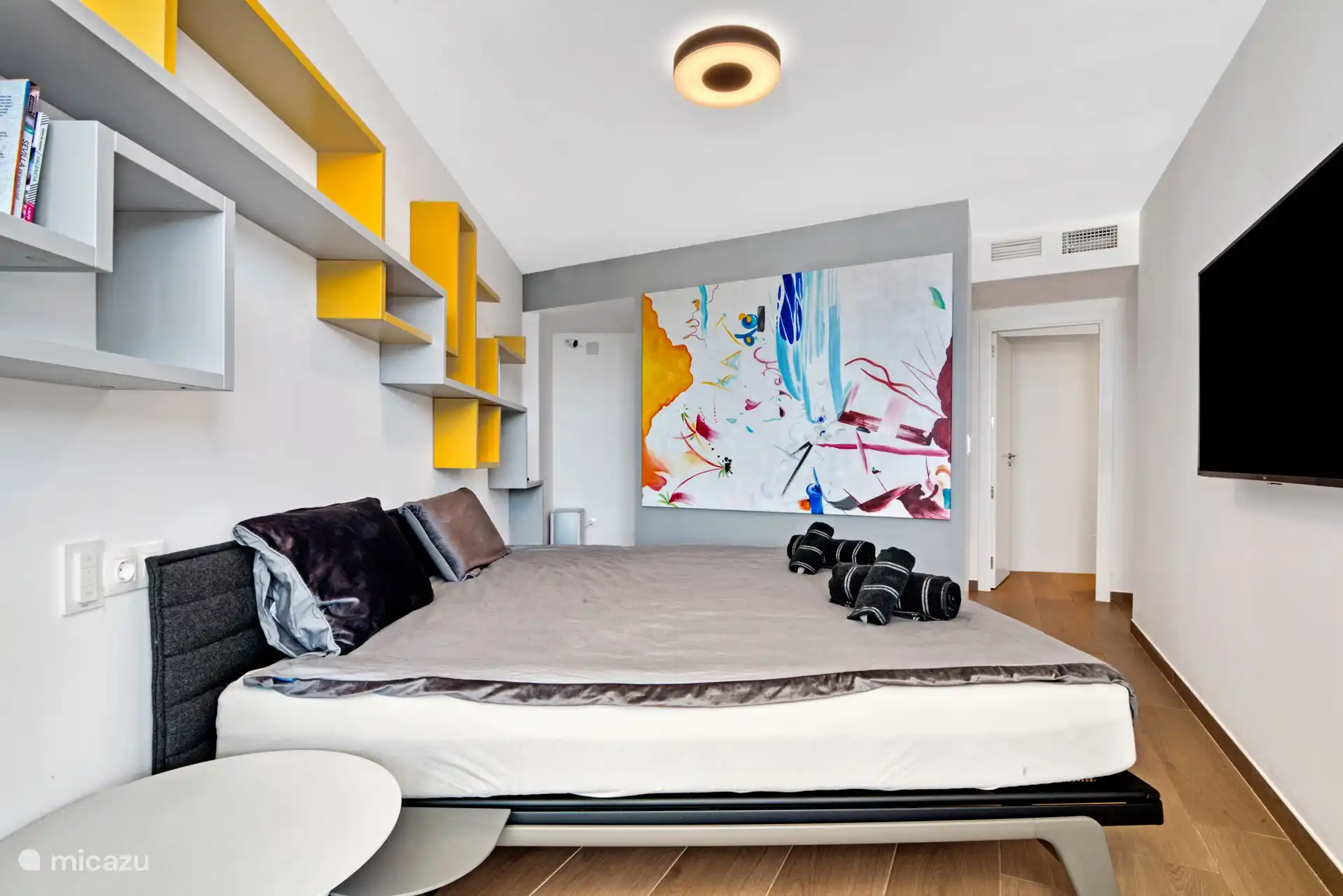 Master bedroom with a beautiful modern painting.