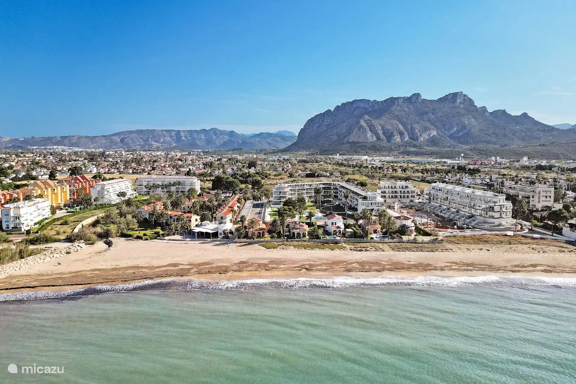 beautiful view of the apartment with the mountains in the background.
