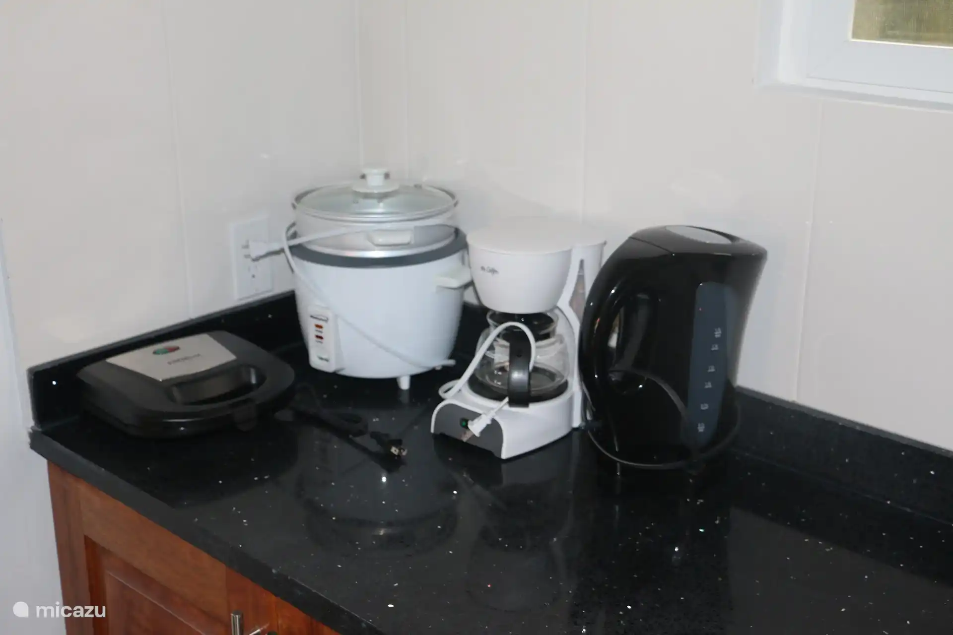The kitchen is fully equipped. There is also an induction hob.