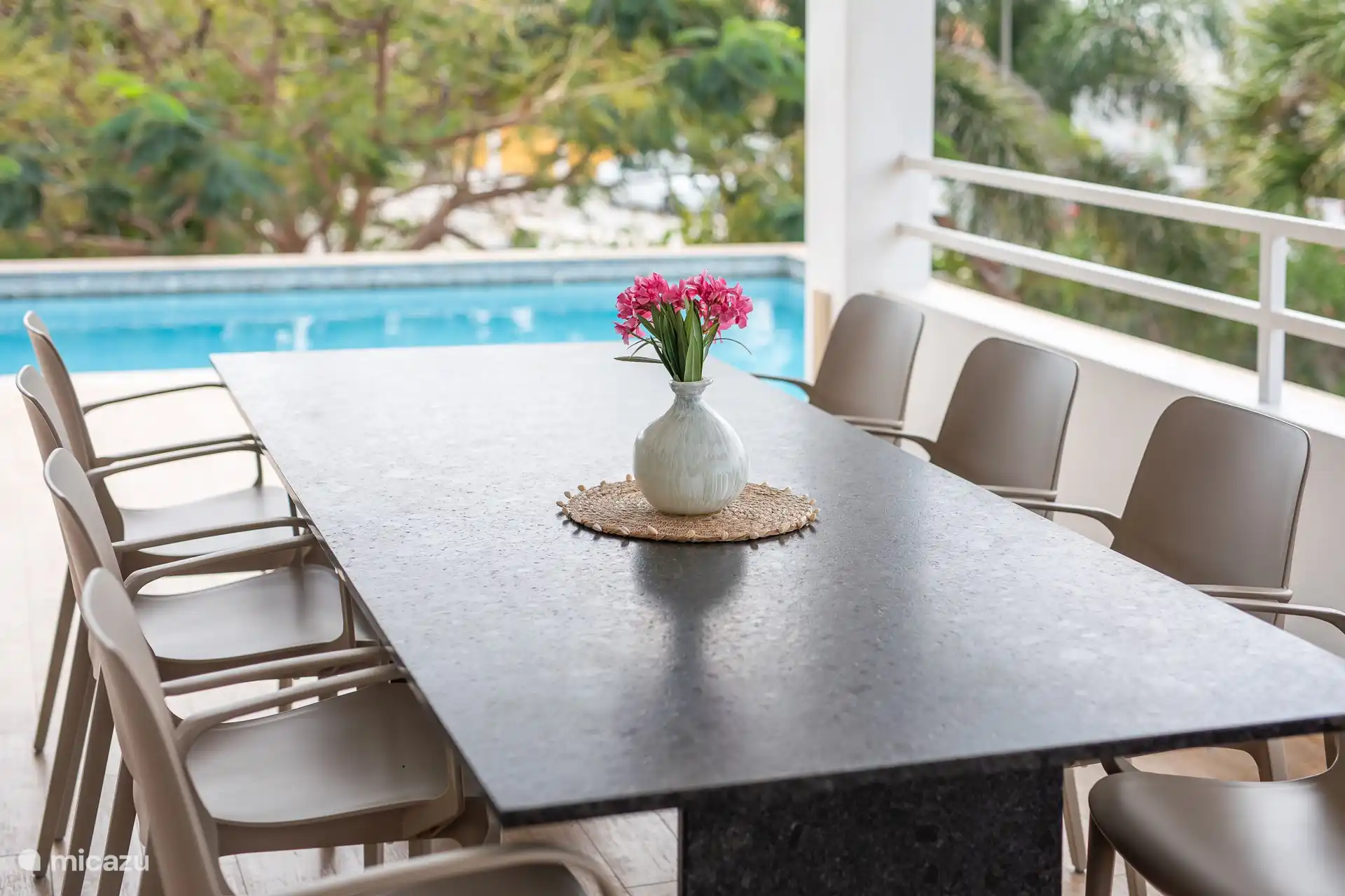 Dining table by the pool on the veranda 
