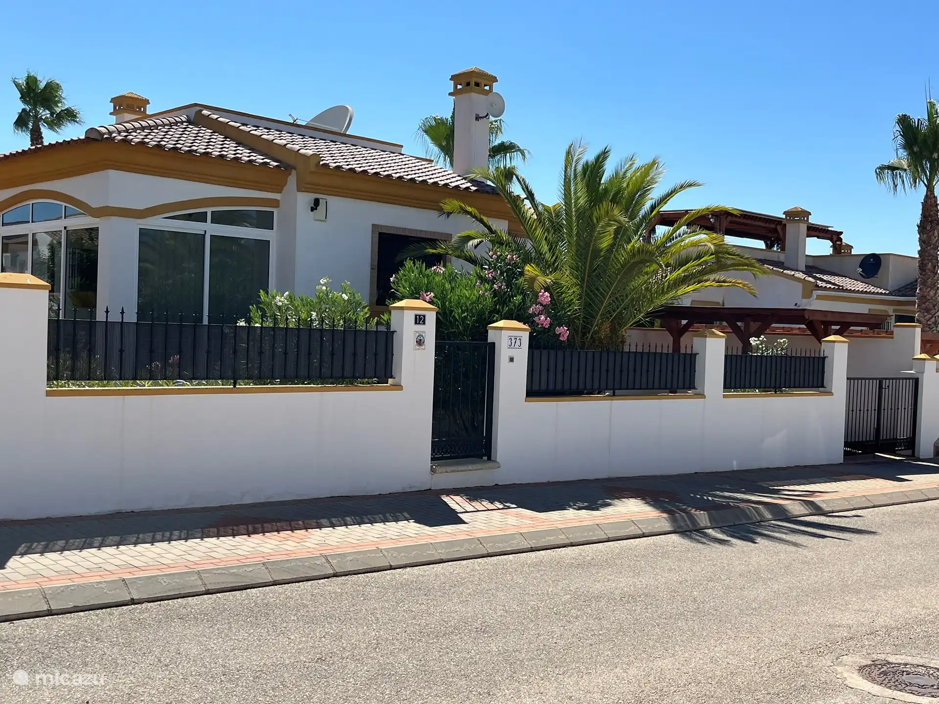 Front view with the covered, closed carport on the far right.