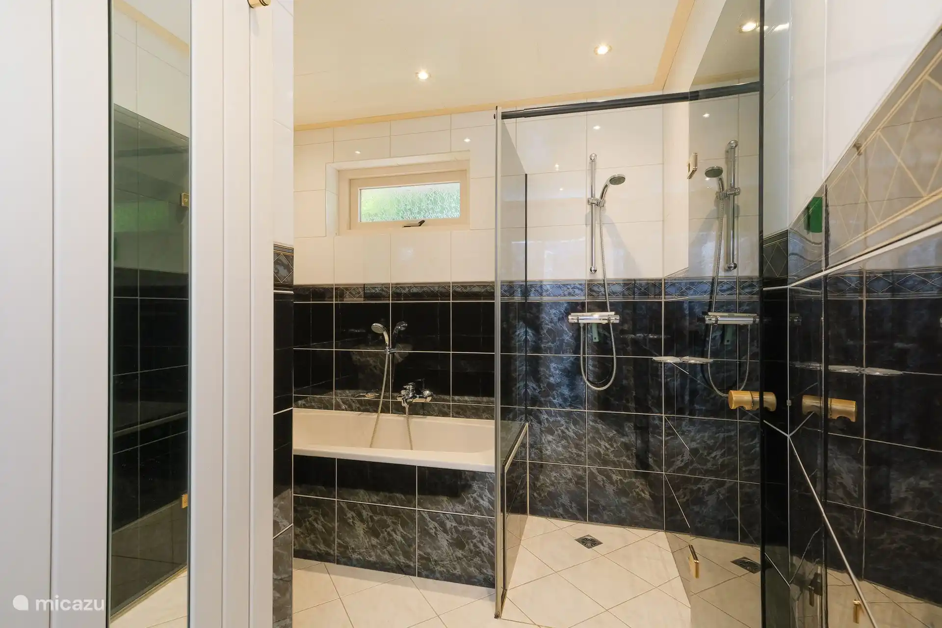 Badezimmer mit geräumiger Dusche, Badewanne und Waschbecken