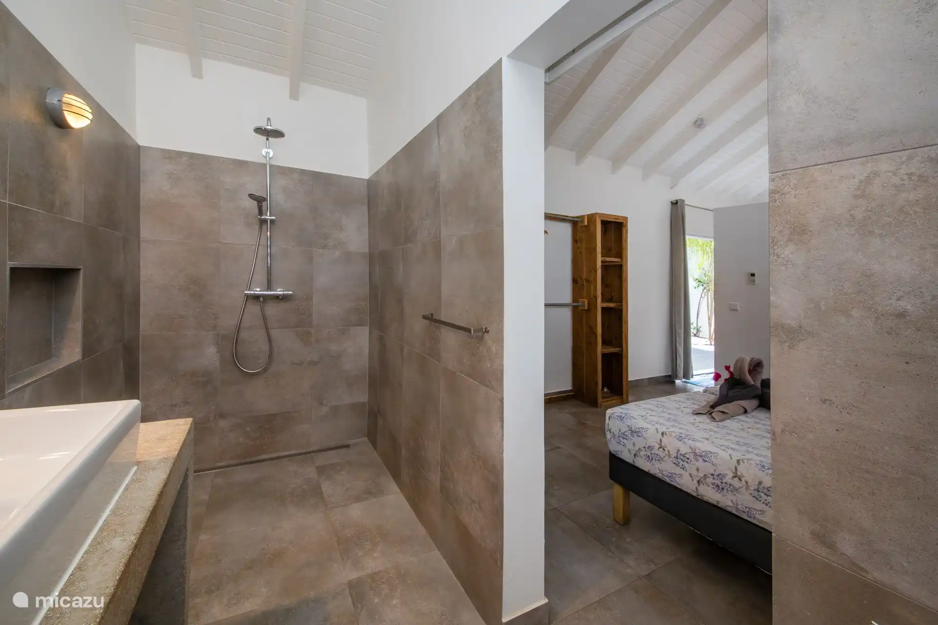 Large, modern bathroom with shower, sink and toilet.