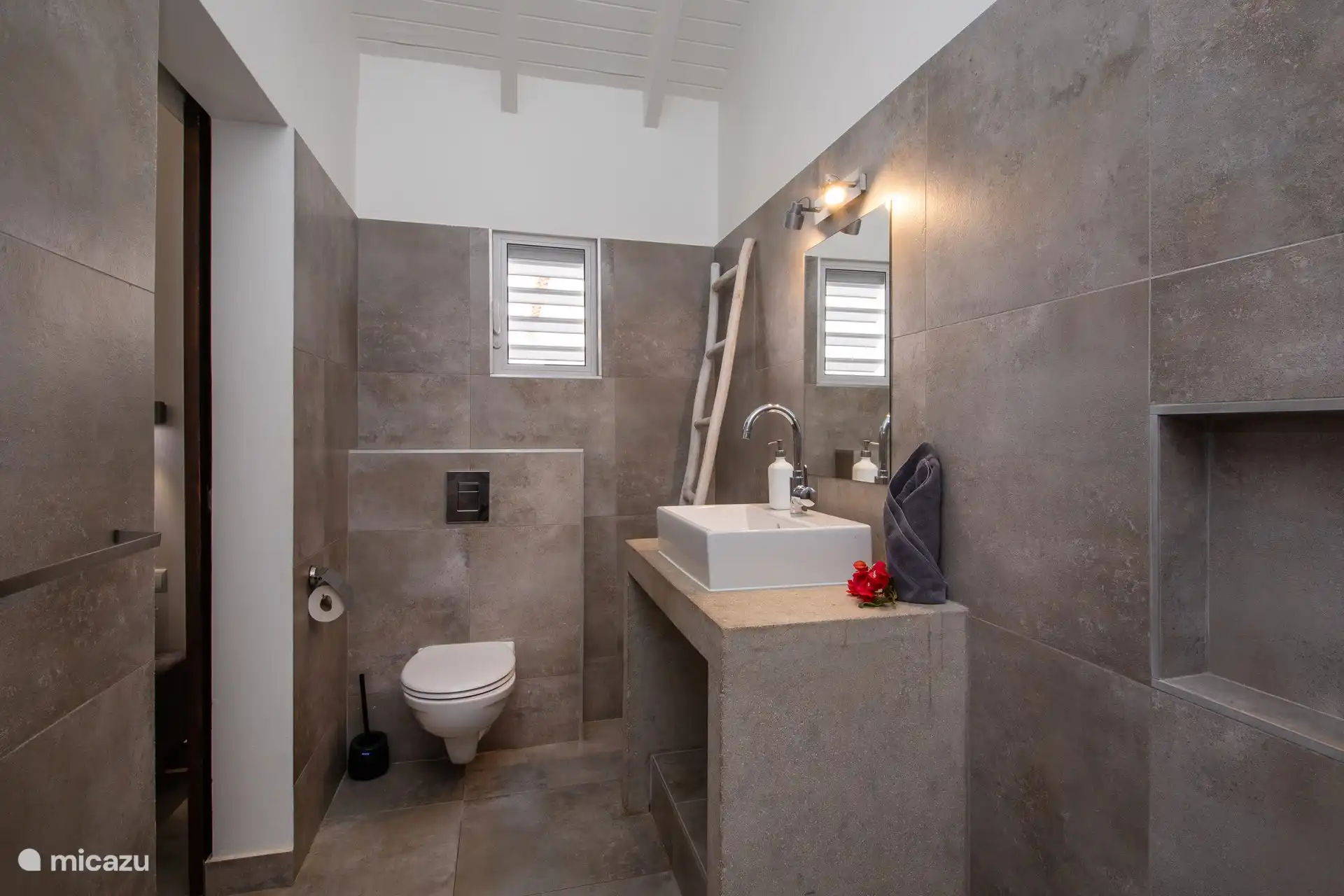 Large, modern bathroom with shower, sink and toilet.