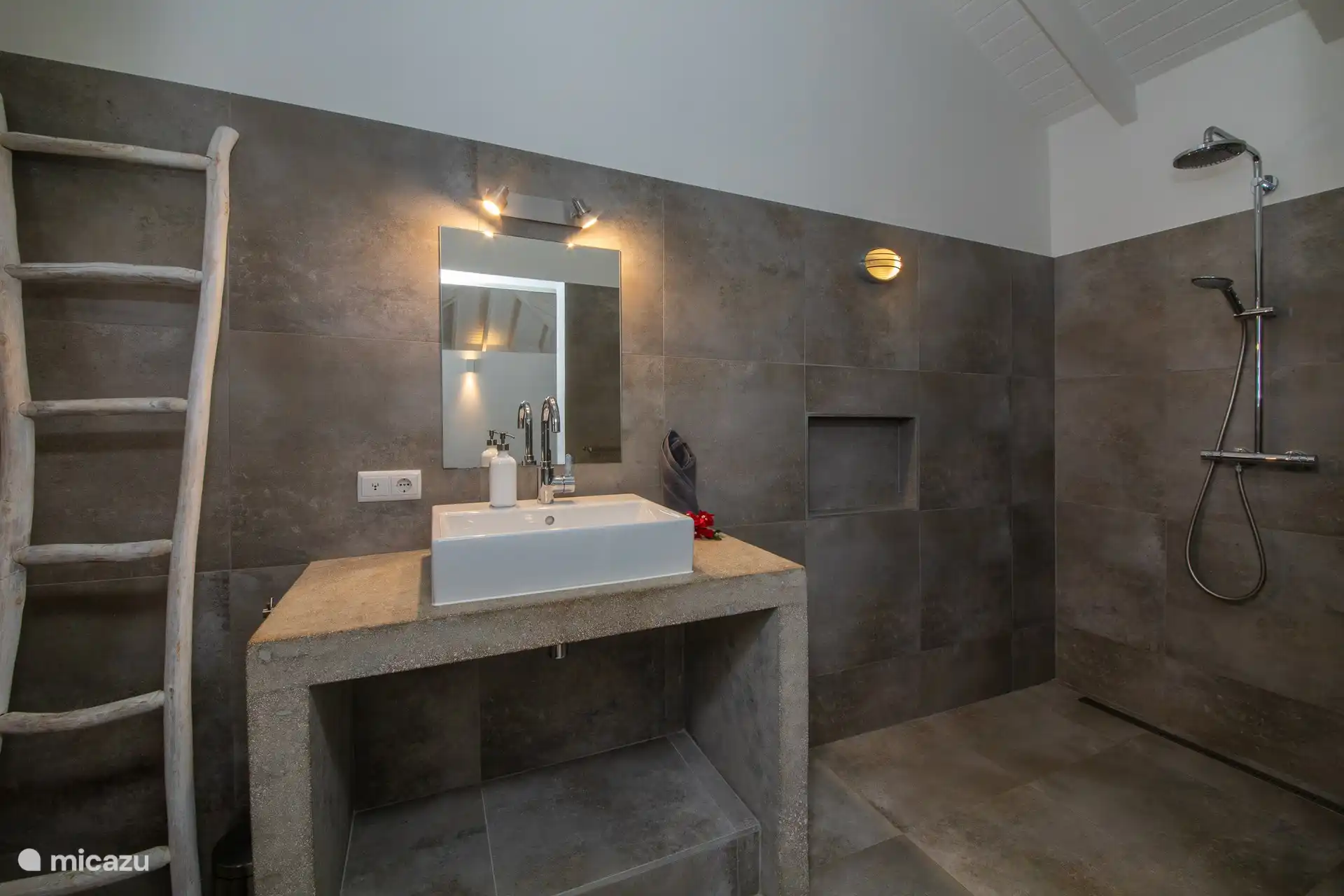 Large, modern bathroom with shower, sink and toilet.