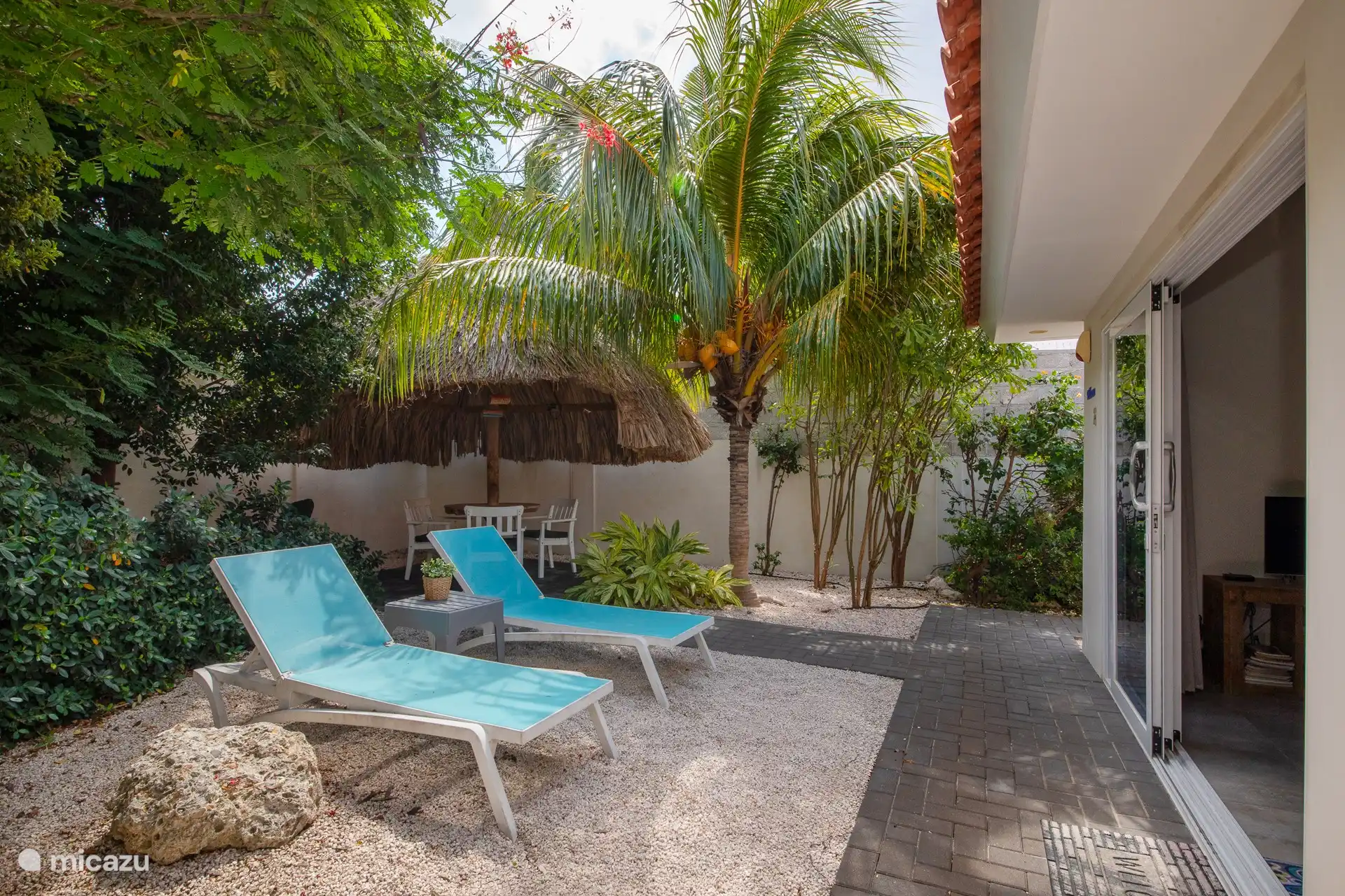 Two-person apartment with private terrace. Seat under the palapa.