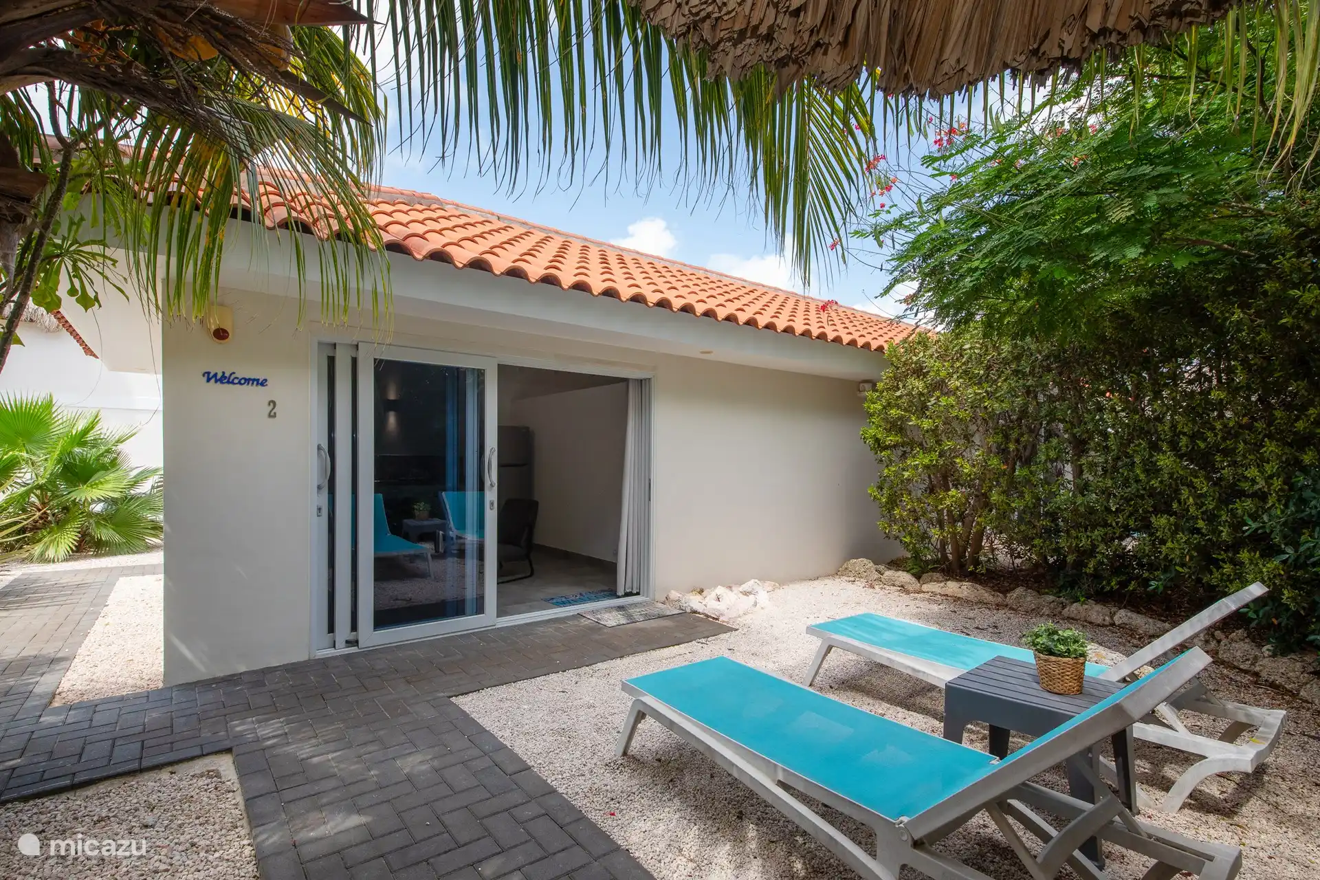 Two-person apartment with private terrace. Seat under the palapa.