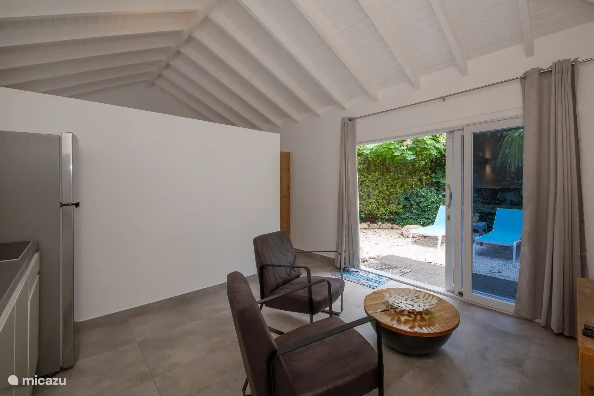 Living room and kitchen in one room.
Armchairs, coffee table and TV