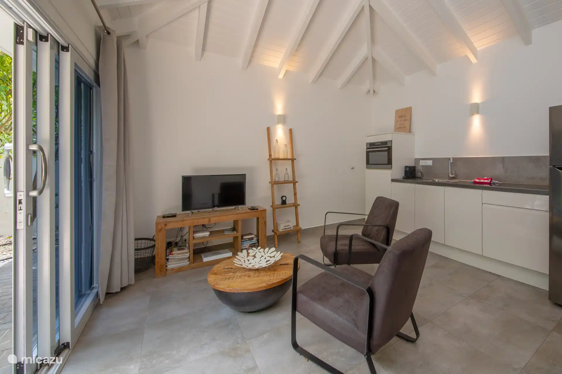 Living room and kitchen in one room.
Armchairs, coffee table and TV