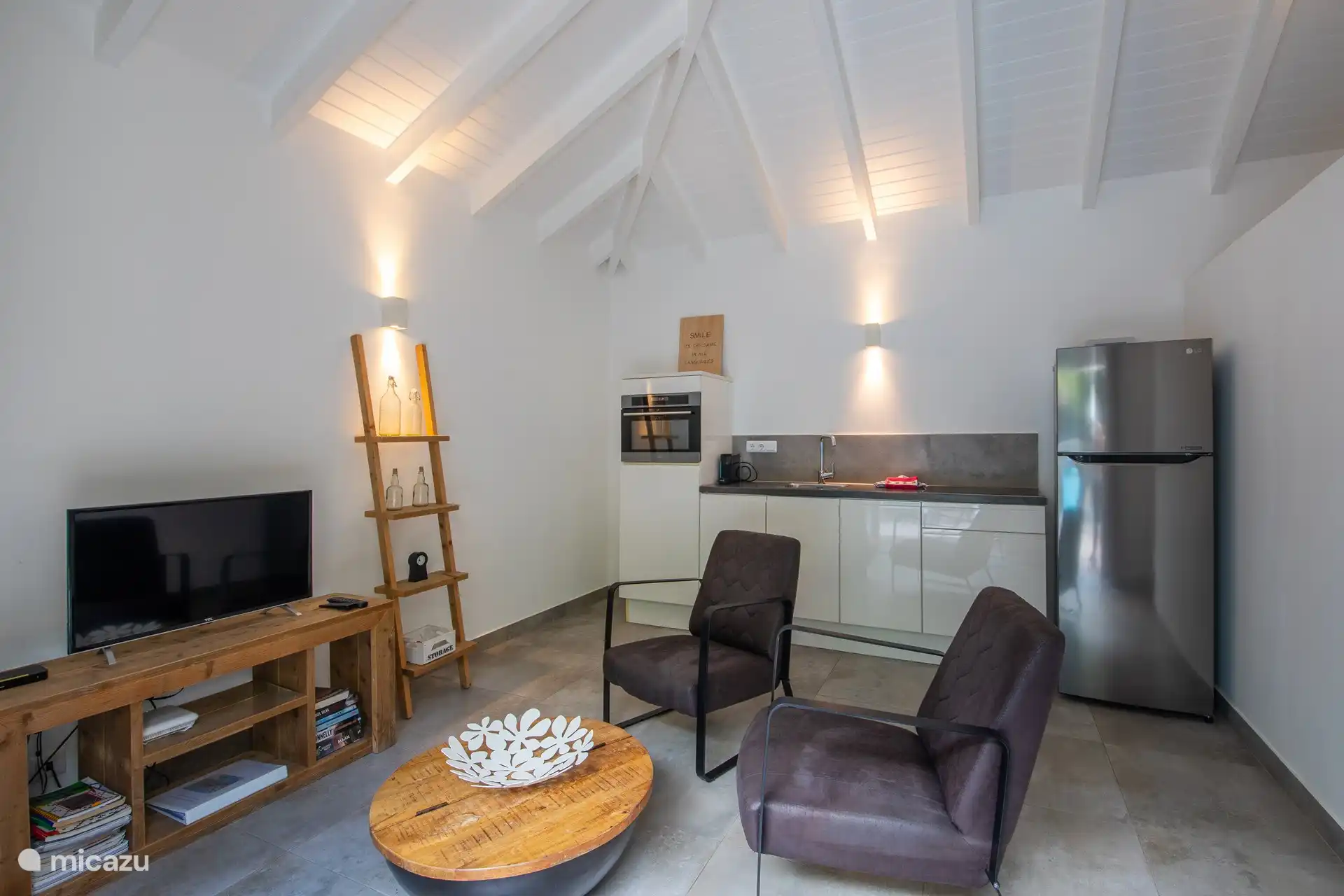 Living room and kitchen in one room.
Armchairs, coffee table and TV