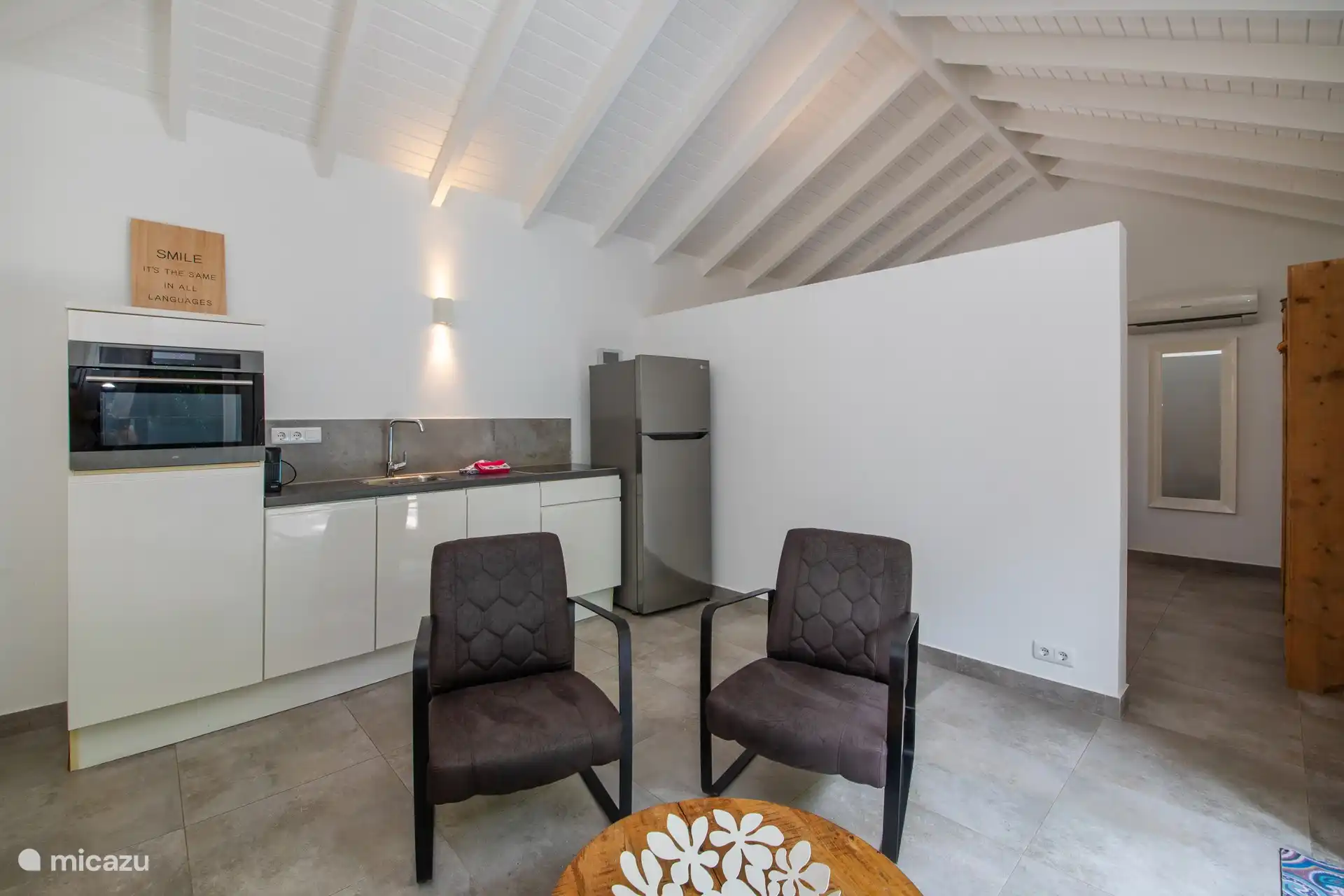Living room and kitchen in one room.
Armchairs, coffee table and TV