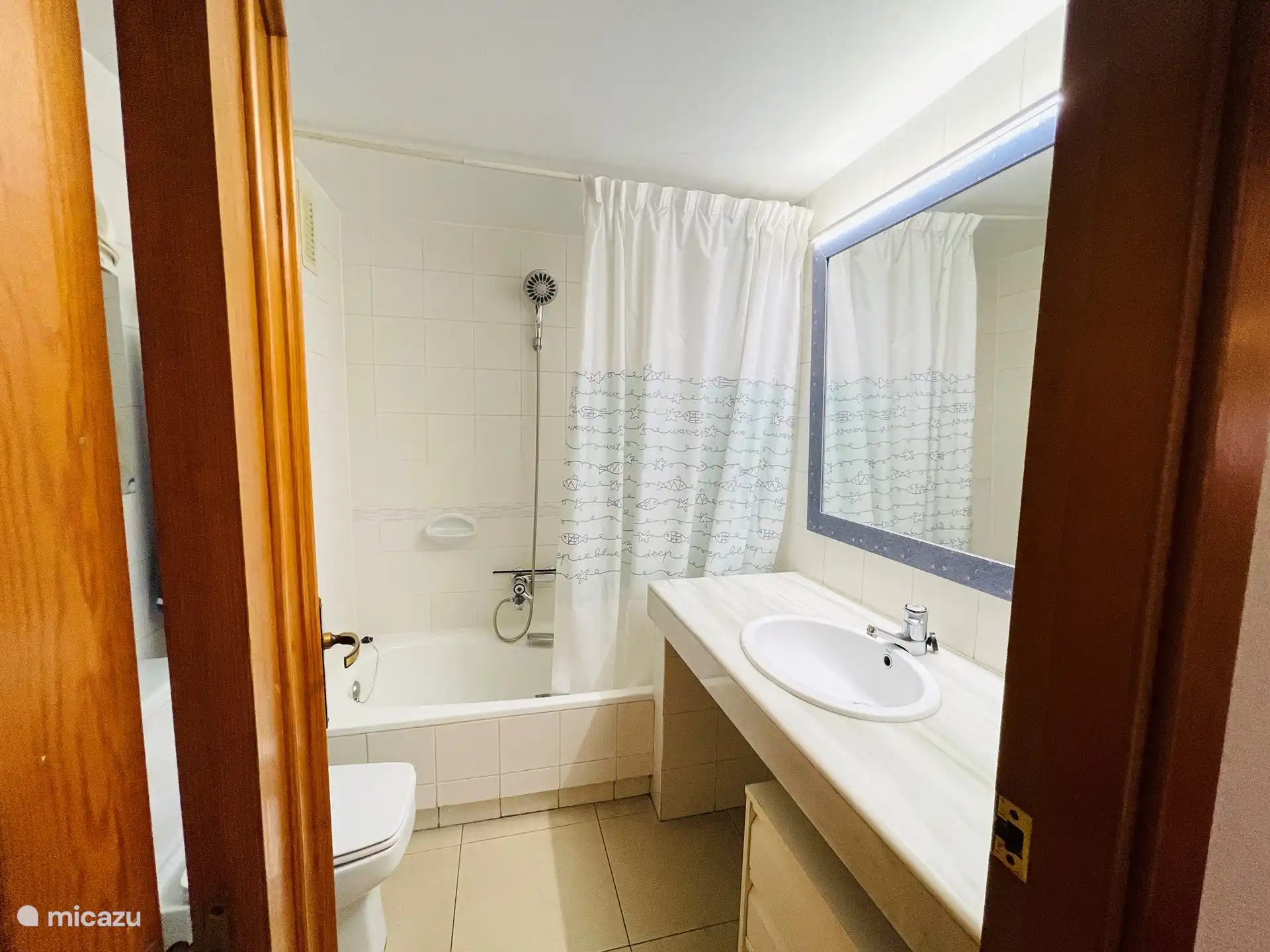 Salle de bain avec baignoire, bidet, WC et lavabo.