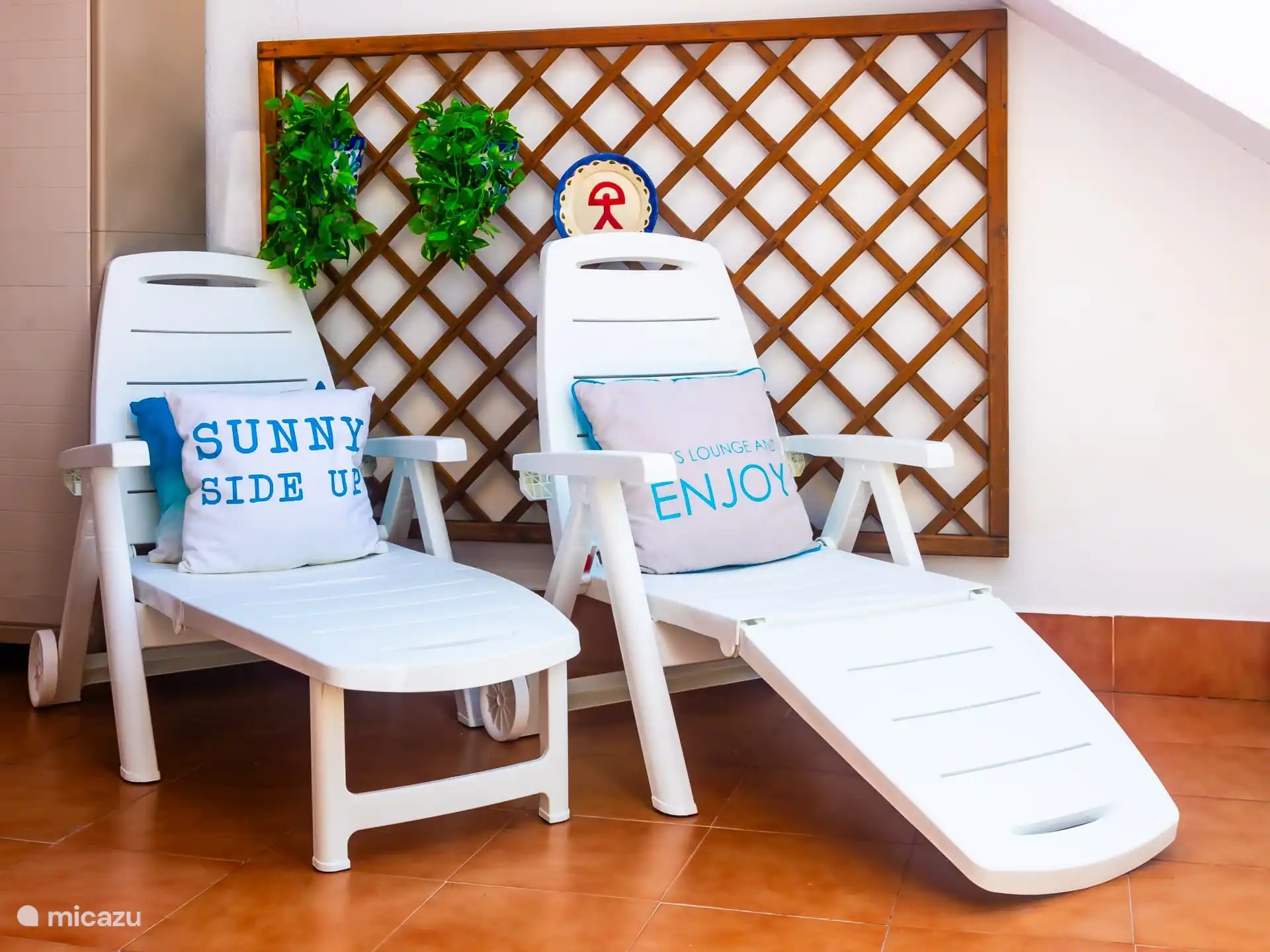 Terras met zonnebedden. 
