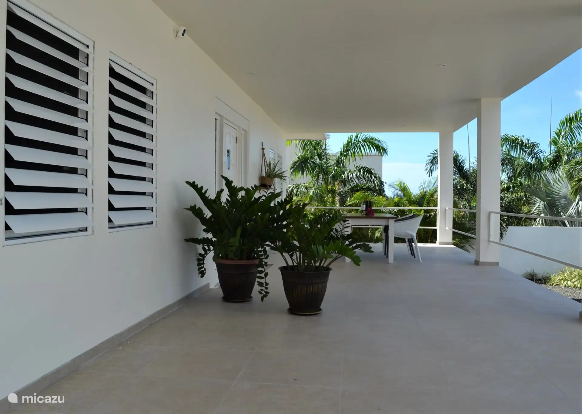 Vorderseite des Hauses mit 6-Personen-Tisch und Lounge-Sofa