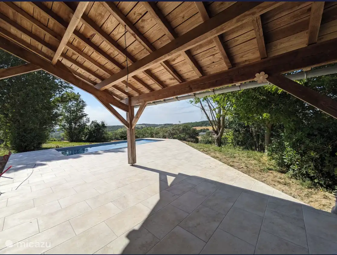 Beautiful south facing covered terrace, adjacent to the kitchen, with views of the pool and valley.