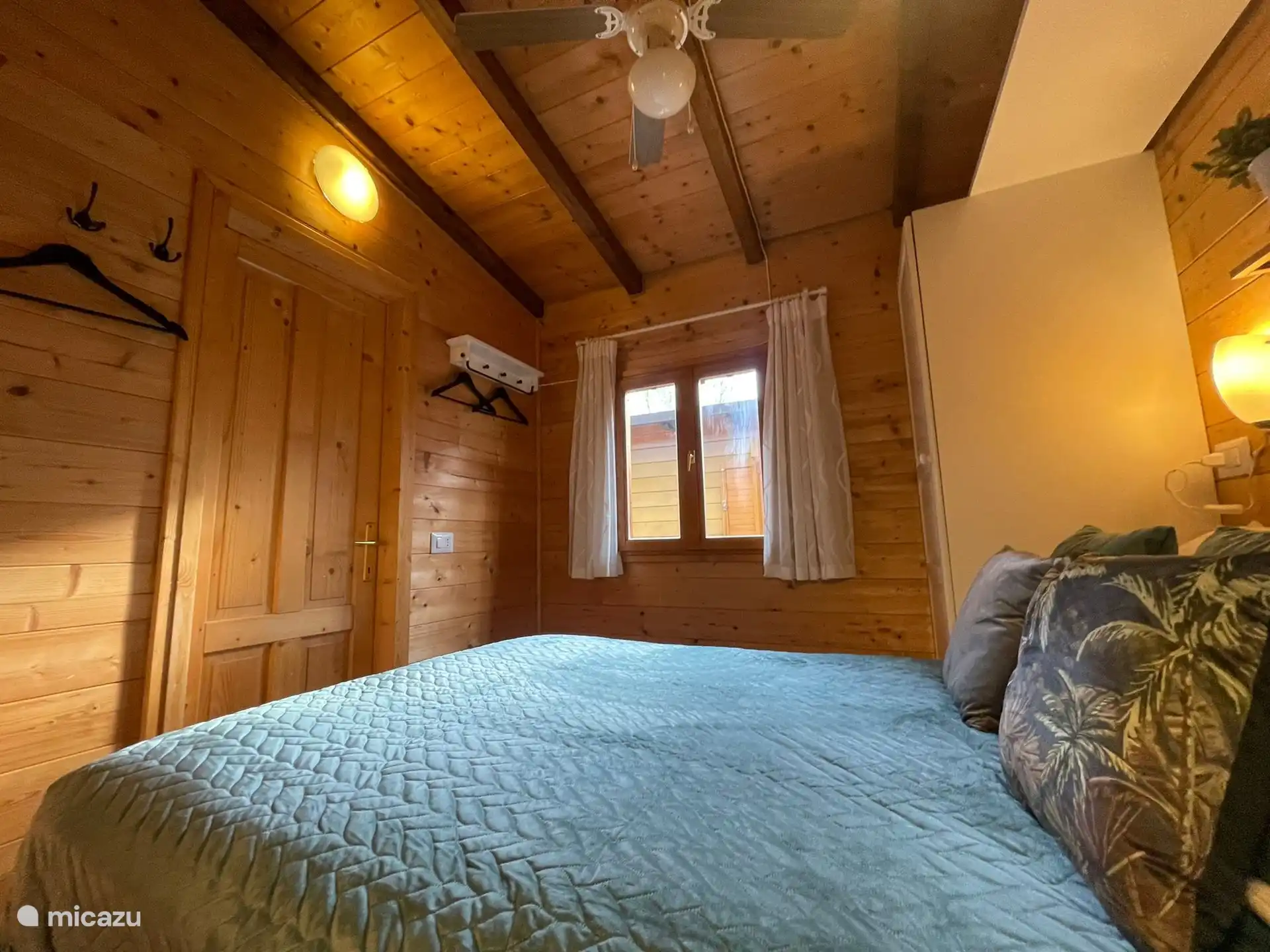 Bedroom 1 with ceiling fan and window screens