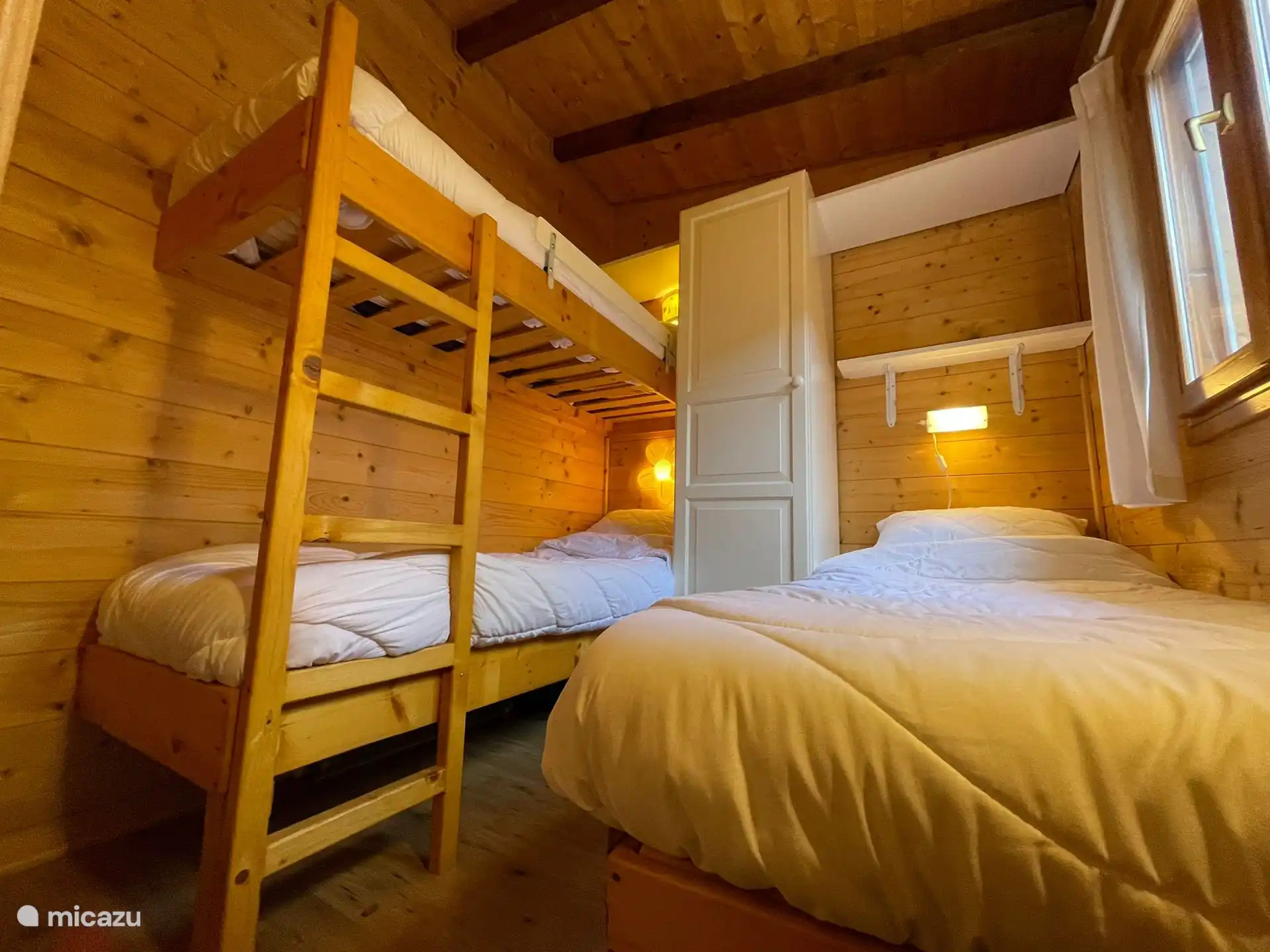 2nd bedroom with bunk beds, single bed, fan and mosquito nets