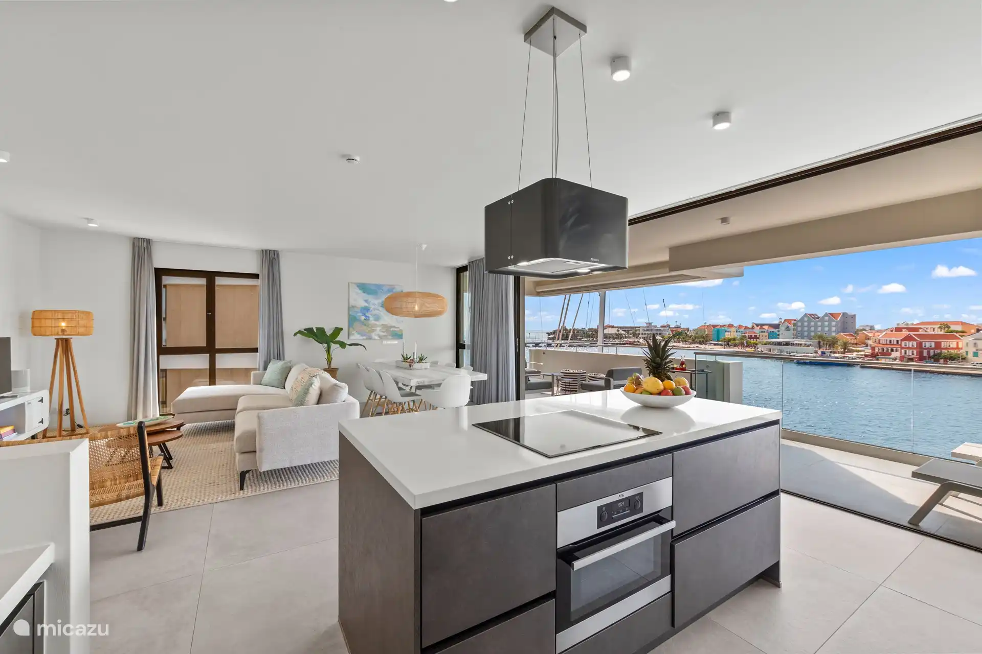 Spacious living room that flows into the balcony, with open kitchen