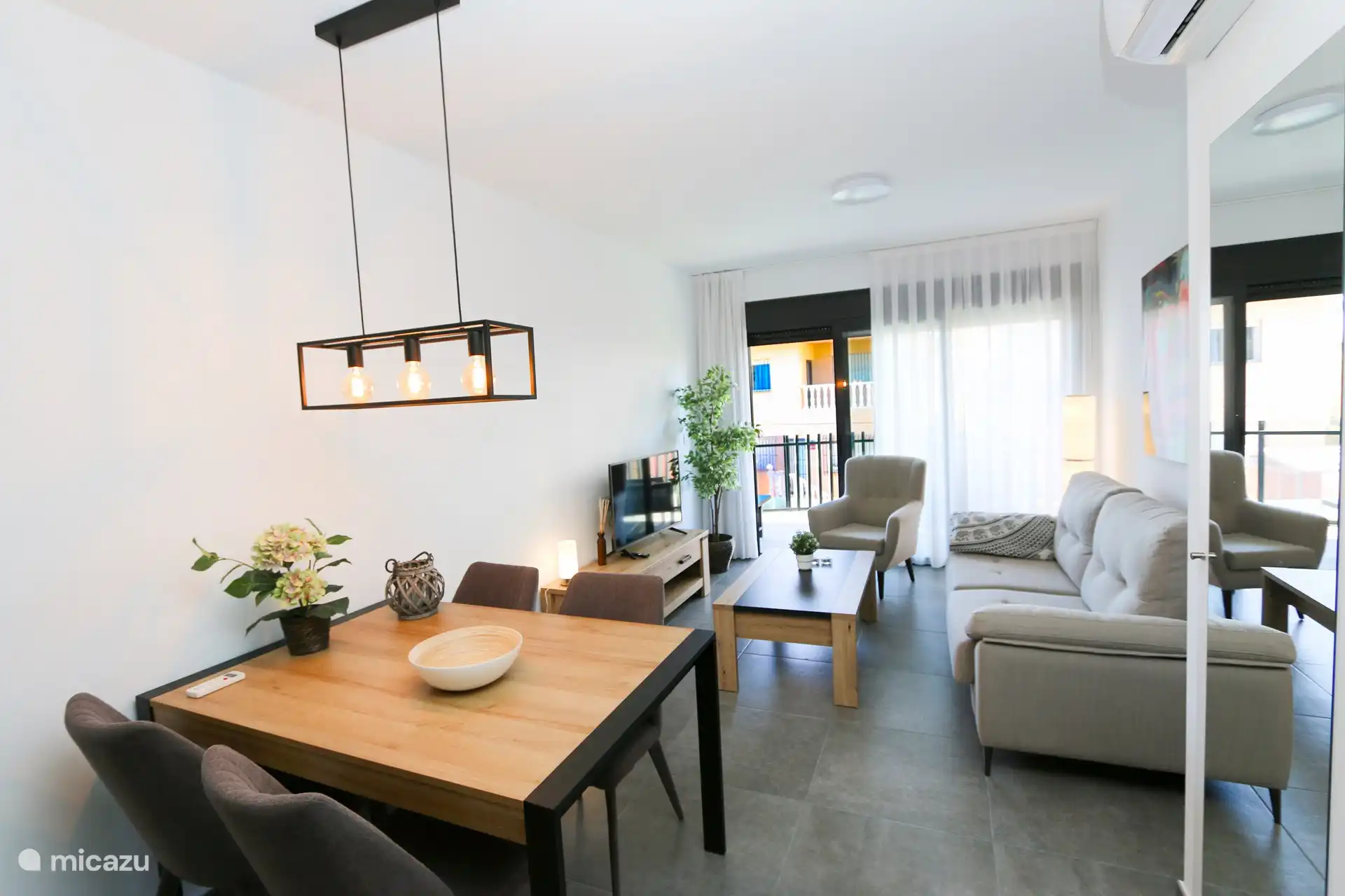 The luxurious living room with the dining table and dining chairs.