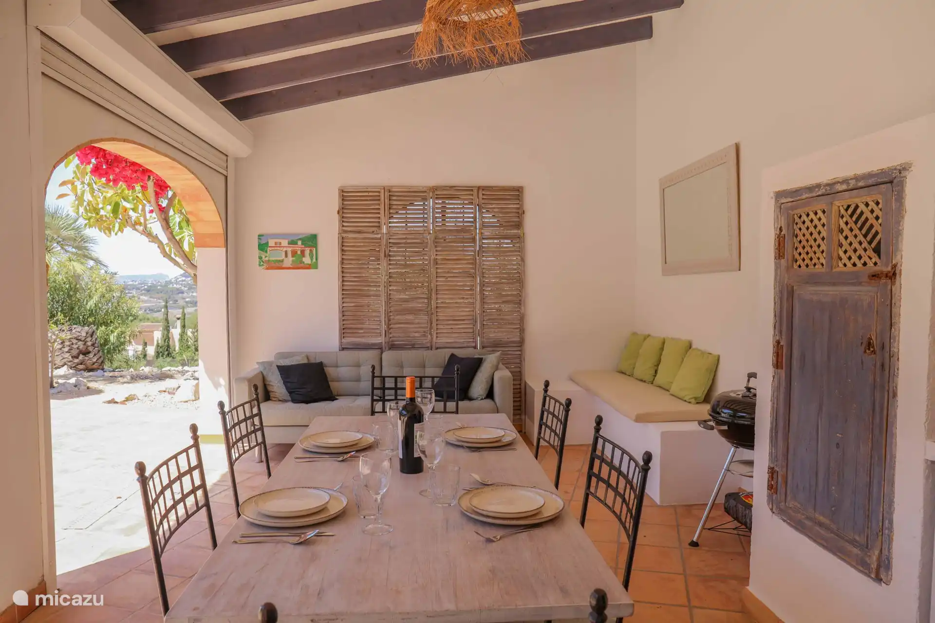 Outdoor kitchen furnished with seating area 