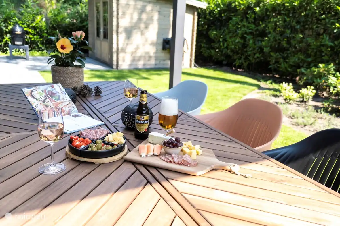 Mesa exterior con 6 sillas bajo dosel que se pueden abrir o cerrar tanto como cerrar. 