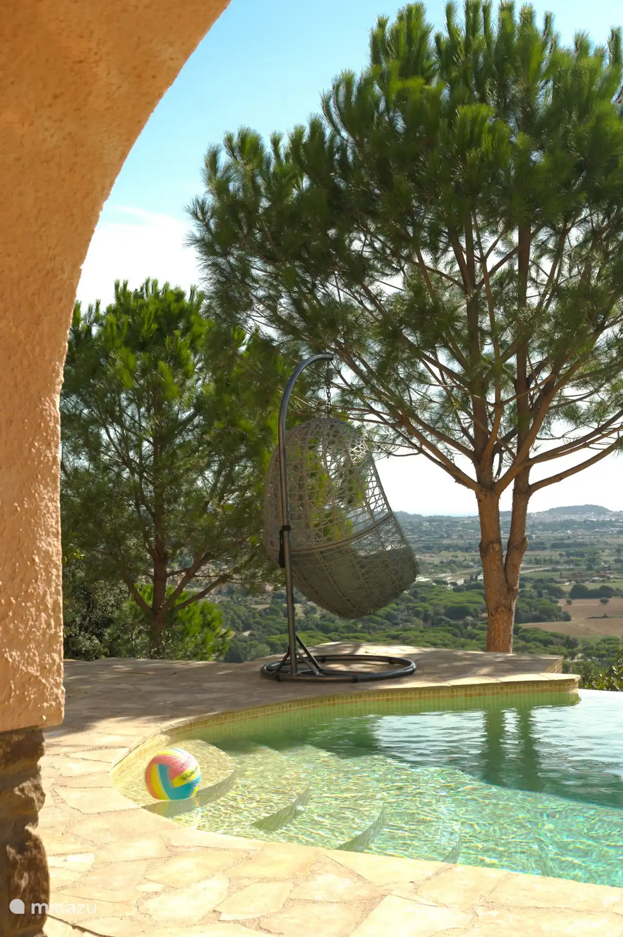 View from the semi-outdoor kitchen to the terrace and swimming pool