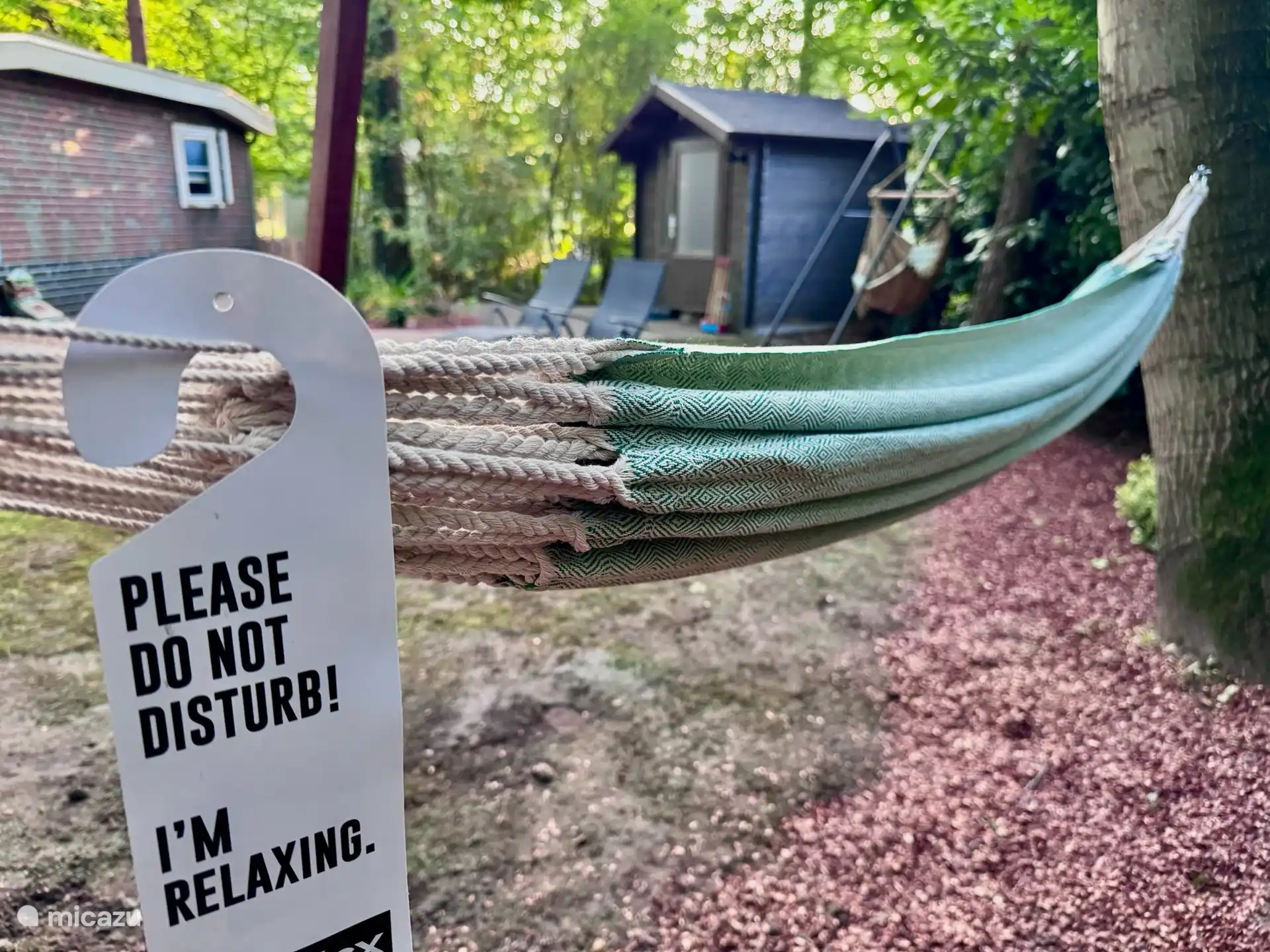 Hamaca en el jardín para un momento de relax entre los árboles.