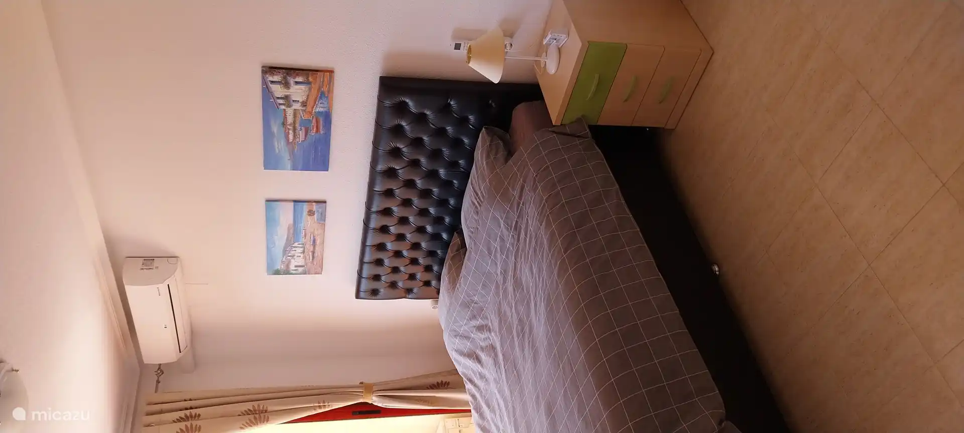 bedroom with open sliding doors to balcony