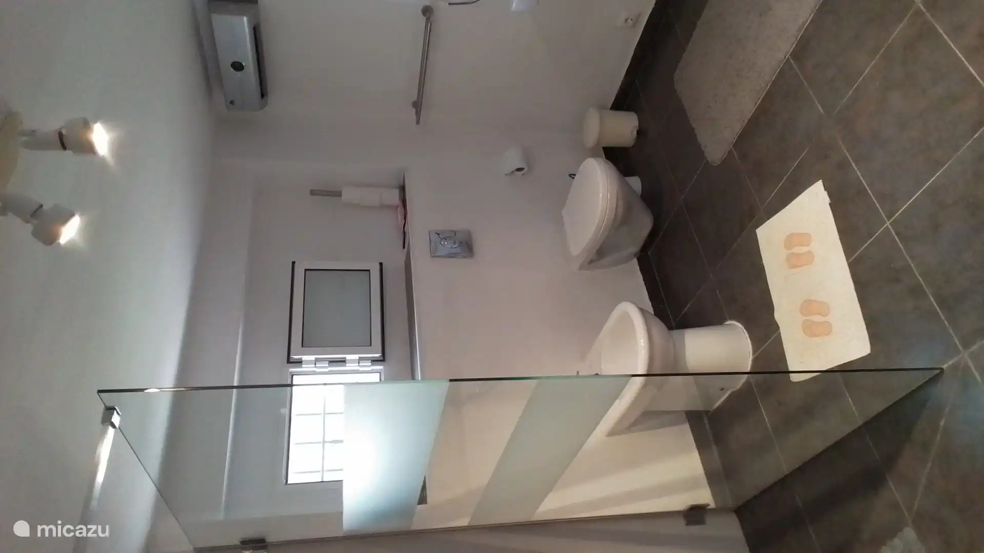 Bathroom with washing machine and dryer.
Toiulet and bidet.